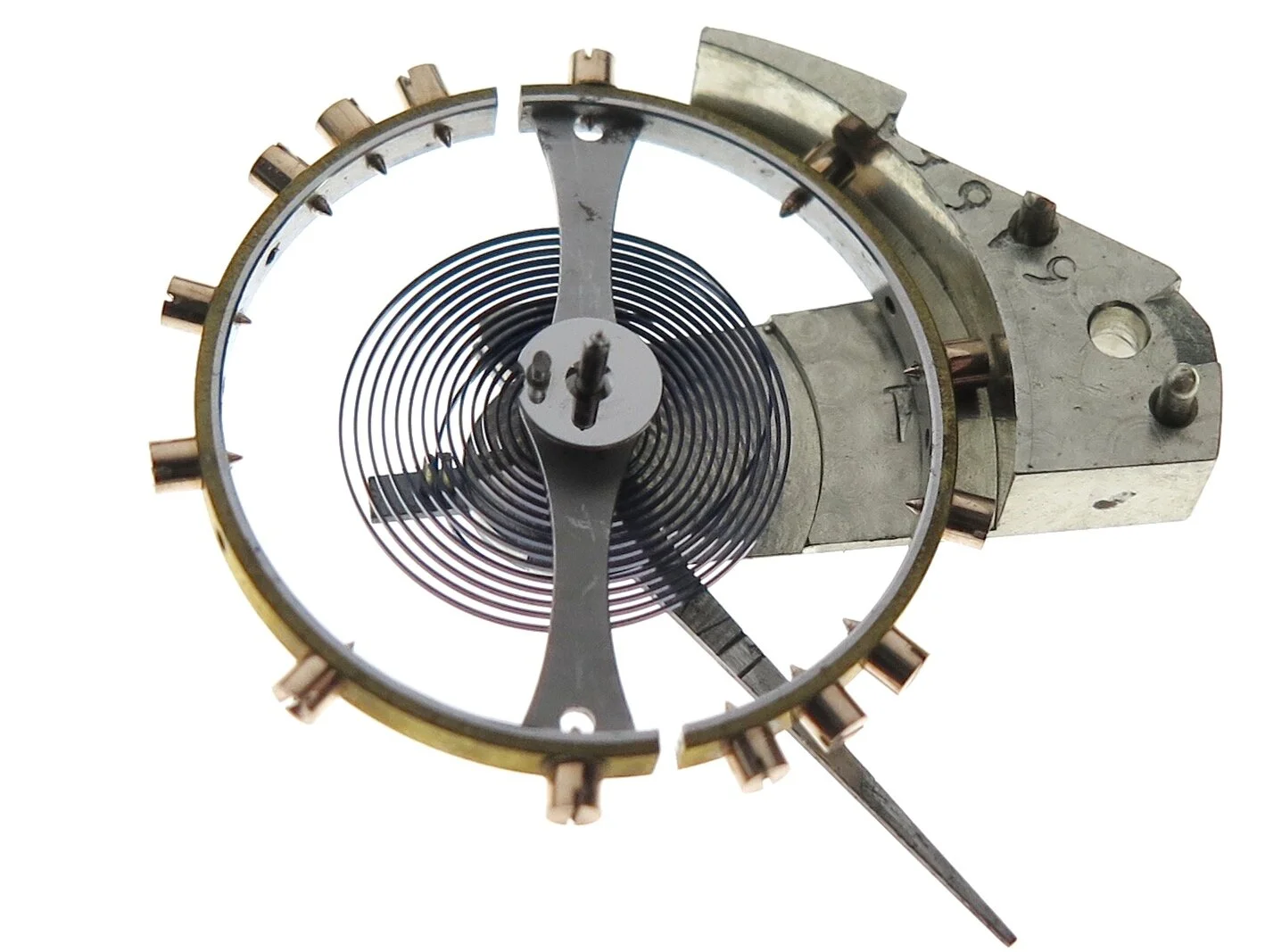 The small elliptical jewel in the centre of the image fixed to the polished steel circular plate is where the escapement lever (anchor) impulses the balance for it to oscillate.