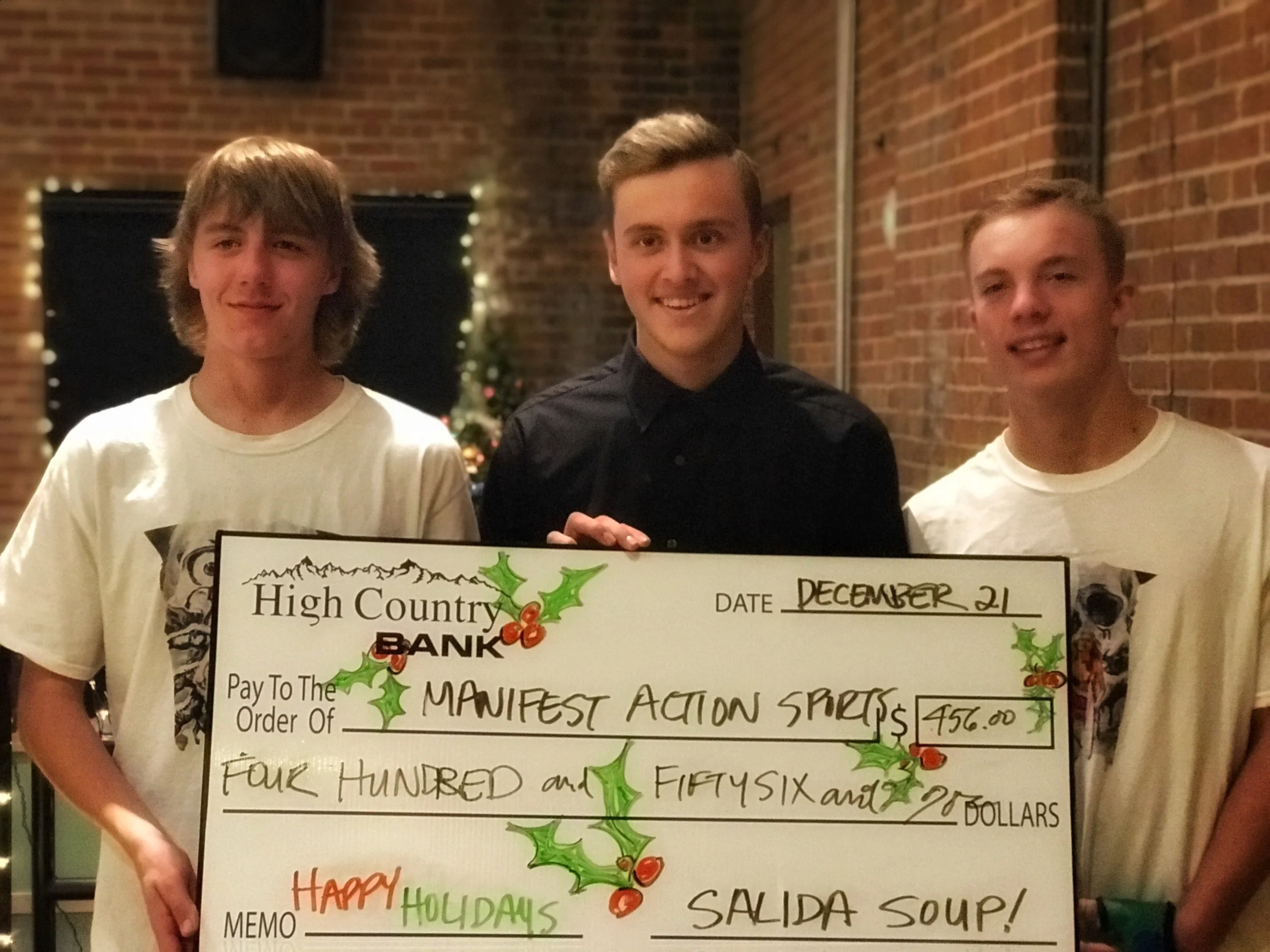 Slaid Waggoner (middle) and the Manifest Action Sports crew posed with the Big Soup Check as the winners of Salida Soup 31 on Thursday, December 21. 