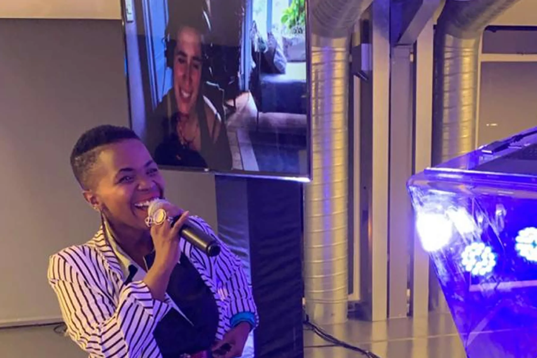 Zolani Mahola from Freshlyground, with Imogen Heap on the screen via Skype, in the background.