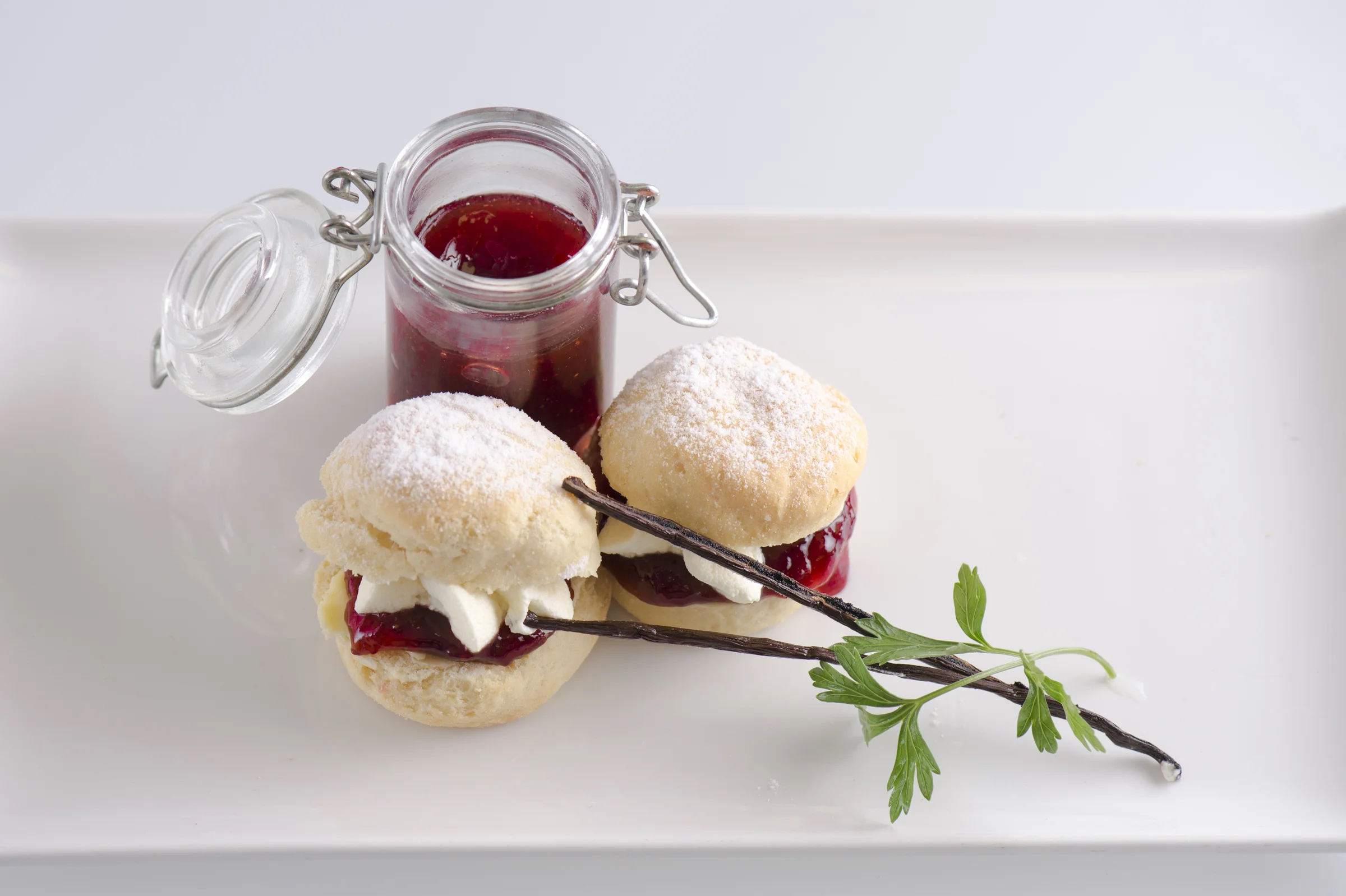 Freshly baked scones with vanilla cream and strawberry jam