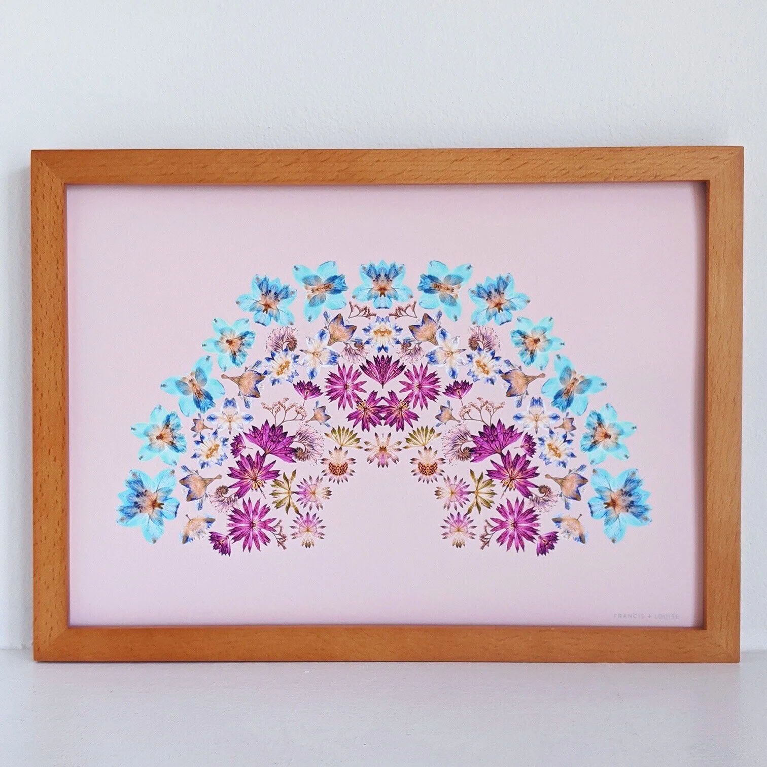 A4 RAINBOW ART PRINT FEATURING A RAINBOW OF PRESSED FLOWERS ON A PEACH BACKGROUND 