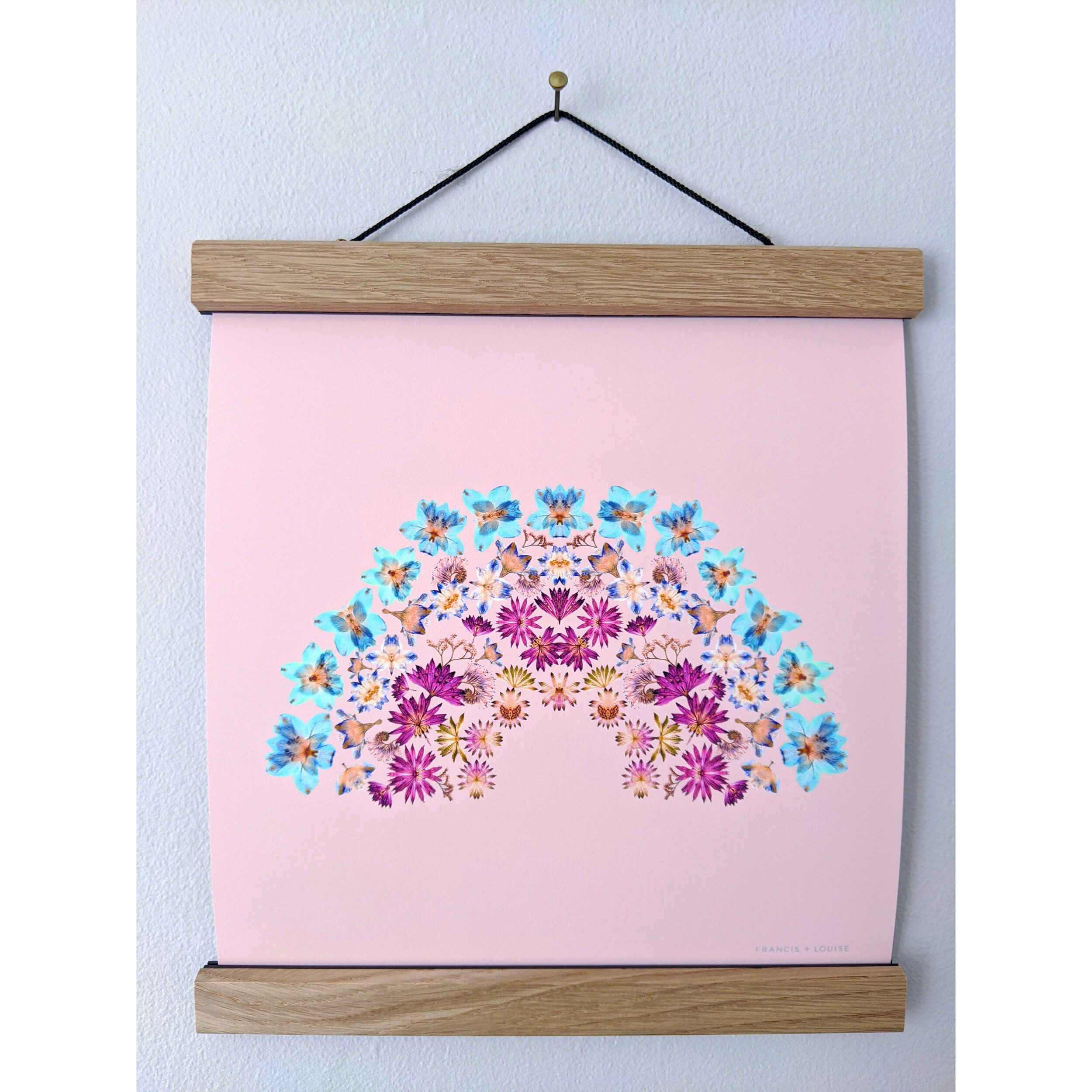SQUARE RAINBOW ART PRINT FEATURING A RAINBOW OF PRESSED FLOWERS ON A PEACH BACKGROUND 