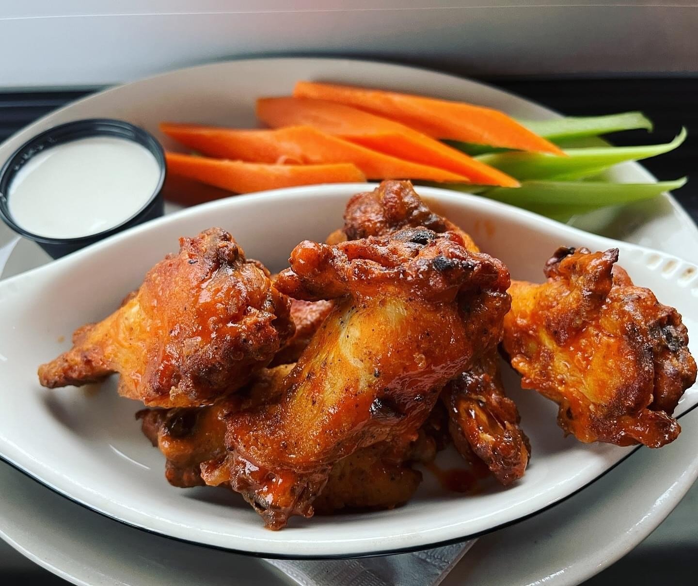 Who wants wings?! Come and get &lsquo;em! Over one pound of seasoned bone in wings tossed in your choice of BBQ, buffalo, or ginger soy. Served with carrots, celery and blue cheese dressing. Available all weekend!