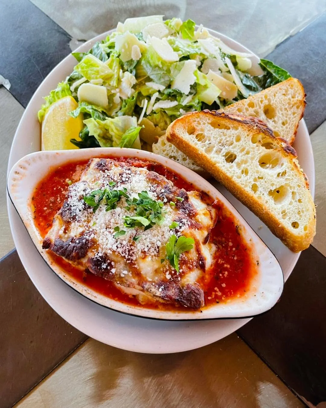 Lasagna with a house-made meat sauce, creamy ricotta, melted mozzarella finished with parmesan &amp; herbs. Served with  fresh focaccia and your choice of a caesar or house salad. Available on special, get it while it lasts!