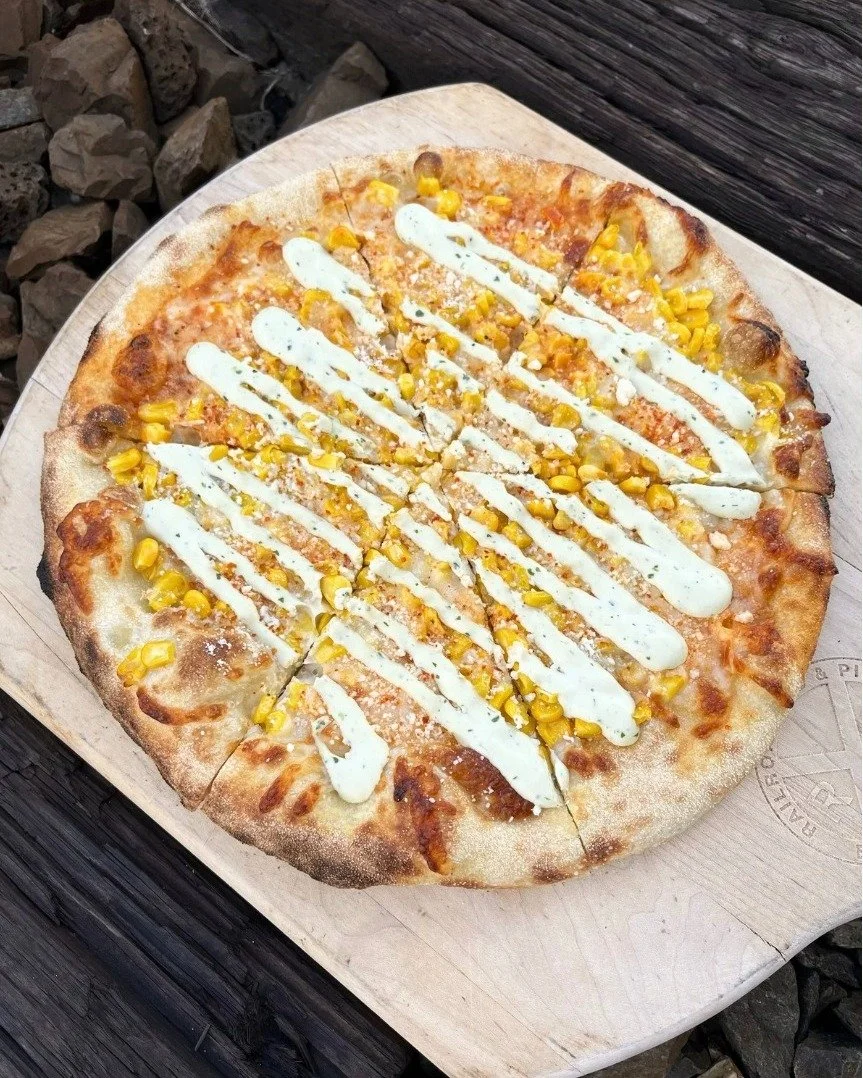 What happens when street corn crashes pizza night? Elote Pizza! Chipotle aioli base and shredded mozzarella. Topped with fire roasted corn, cilantro, cojita cheese &amp; tajin. Finished with an avocado crema. Available on special for a couple of week