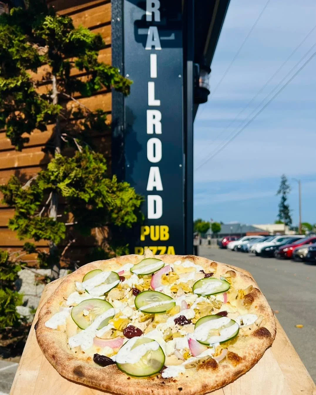 It&rsquo;s a beautiful evening at Railroad! Try our Greek Chicken Pizza&mdash;Fresh mozzarella, chicken, artichoke hearts, red onion, Kalamata olives and feta cheese! Topped with thinly sliced cucumber and our house made tzatziki sauce.