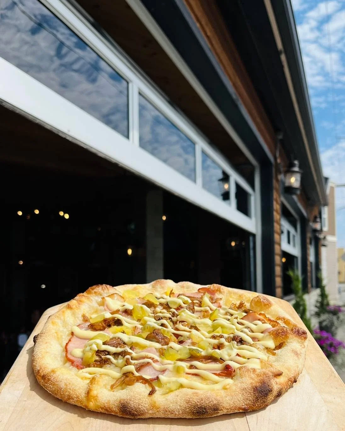 It&rsquo;s back! 😎 Cuban Pizza&mdash;Swiss cheese, Jack Mountain Meats Ham, TrainWreck Bar &amp; grill&rsquo;s smoked pork, topped with chopped pickles &amp; our house made Dijon Aoili. Available for a couple of weeks here at Railroad!