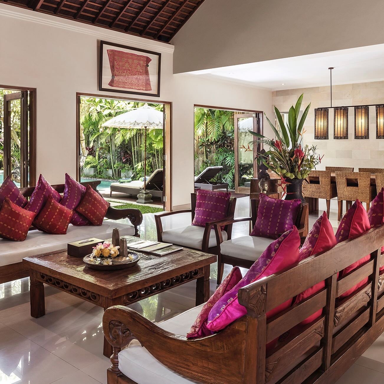 Contemporary Balinese interior design from the living room across to the dining room at Villa Songket. #bali #baliholiday #balistyle #baliliving #tropicalasianatmosphere #balidesign #balivilla #tropicalstyĺe #tropical #visitbali