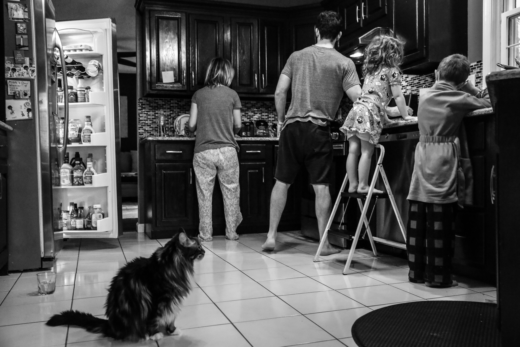 Family gets ready for breakfast with cat