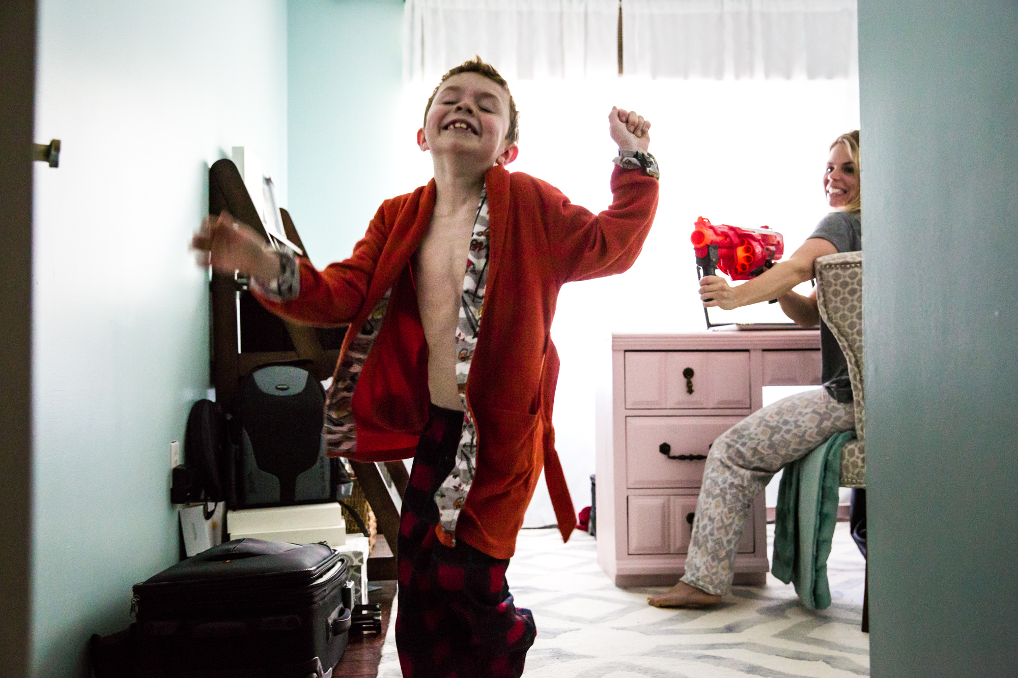 Boy in red robe gets hit with nerf gun