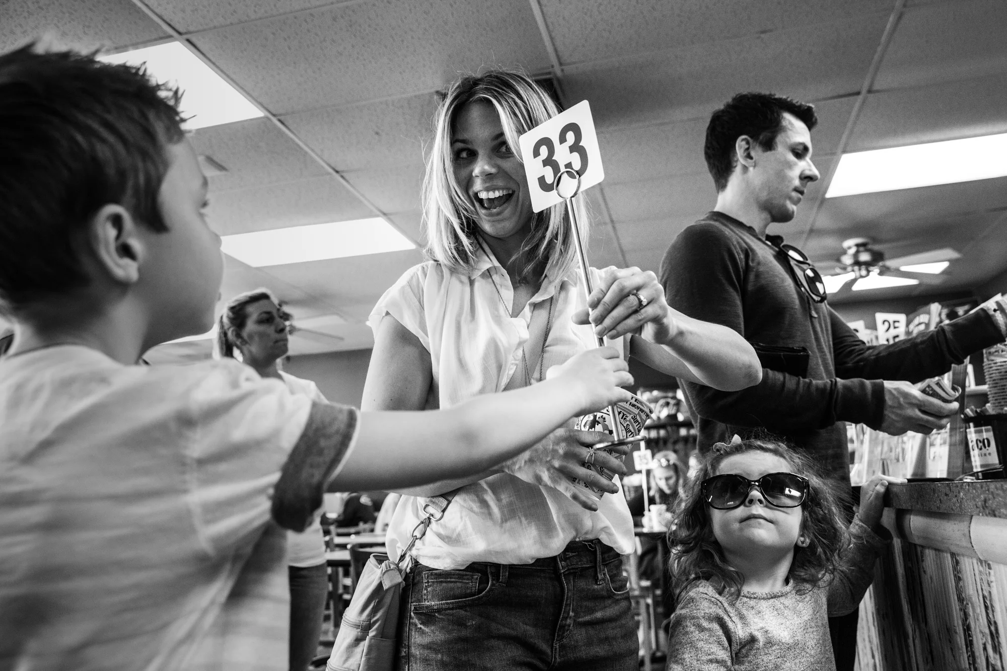 Women holds up number in que at restaurant