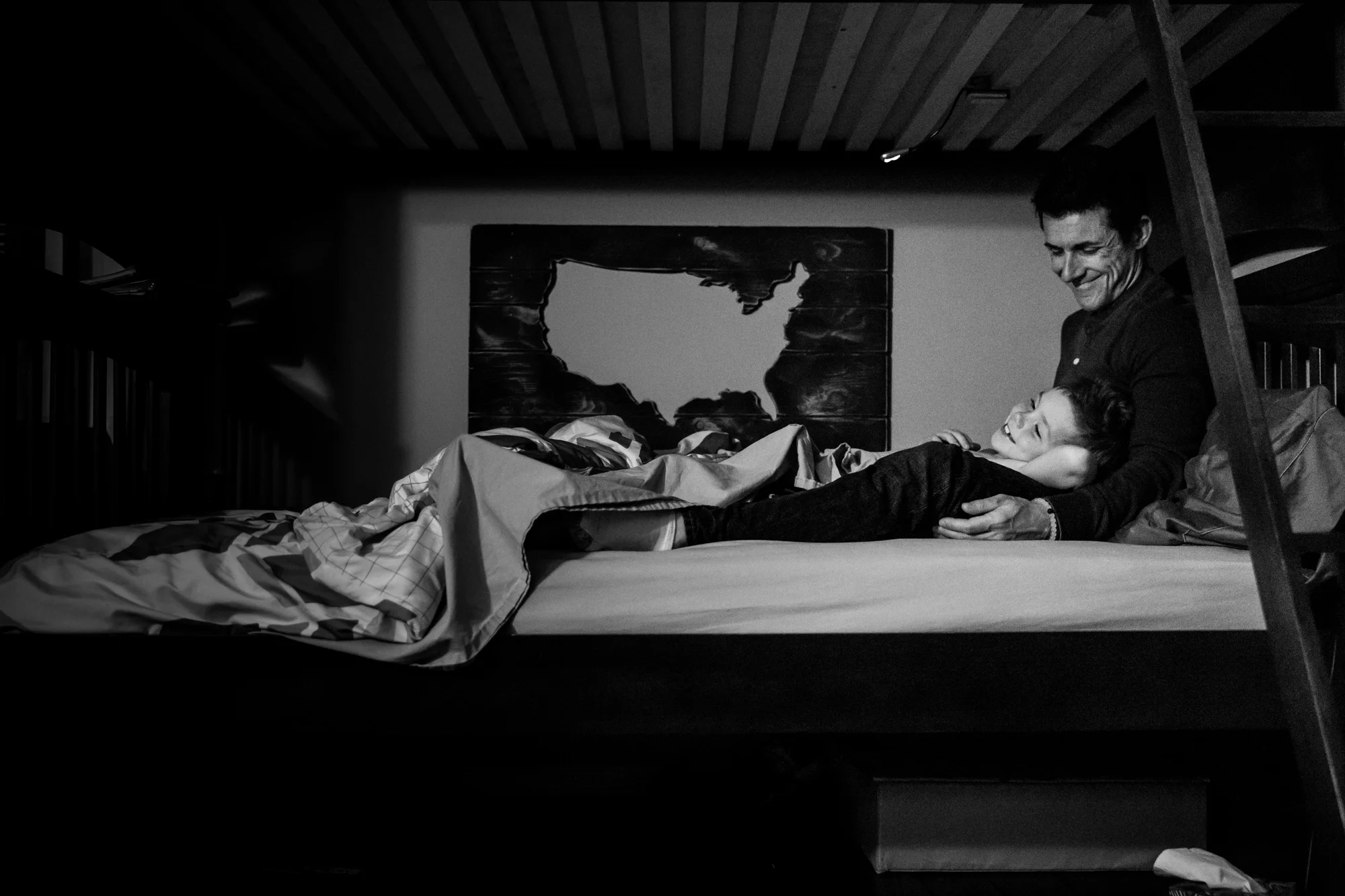 Father and son lay in bed
