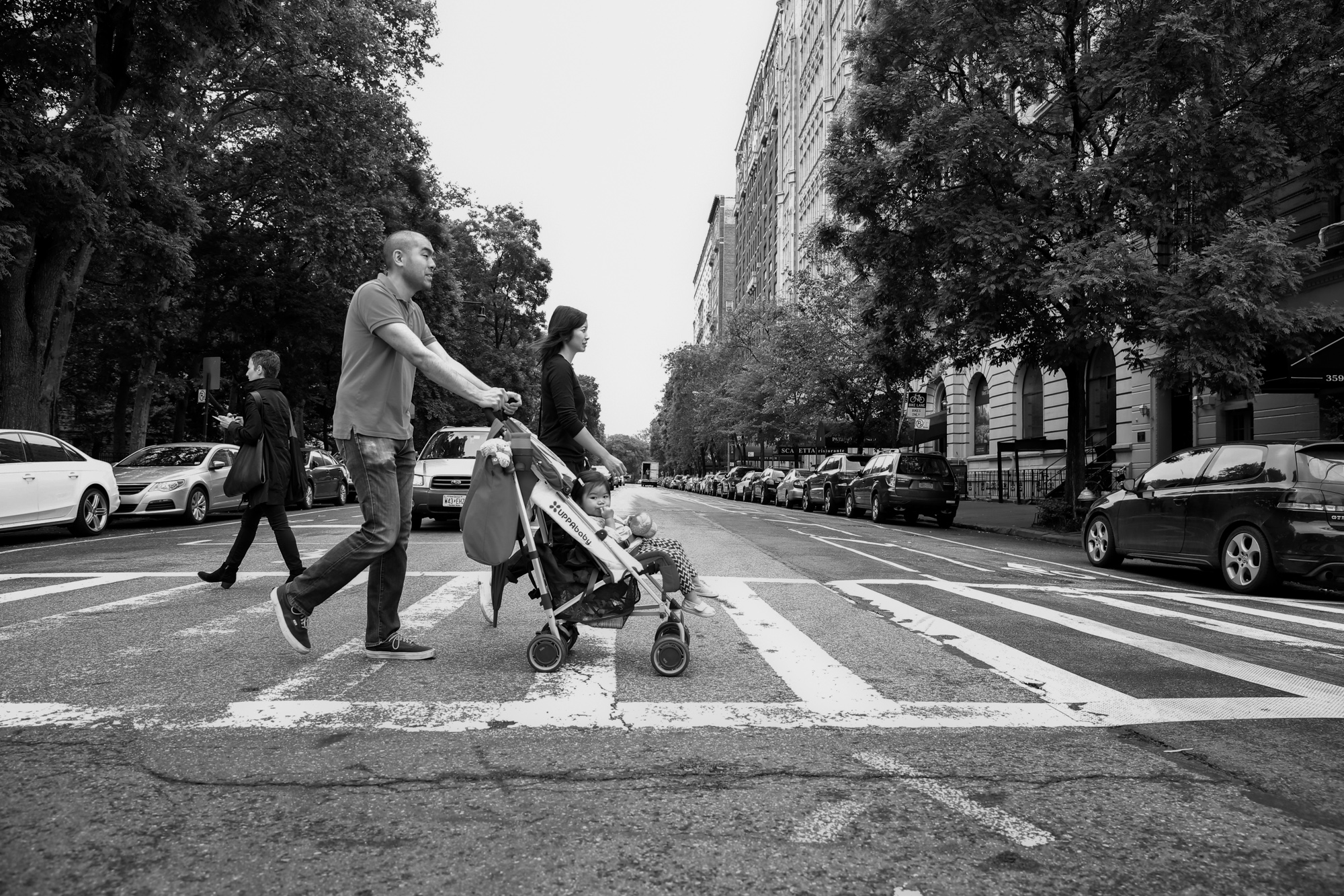 Family of 3 crosses the street in NYC