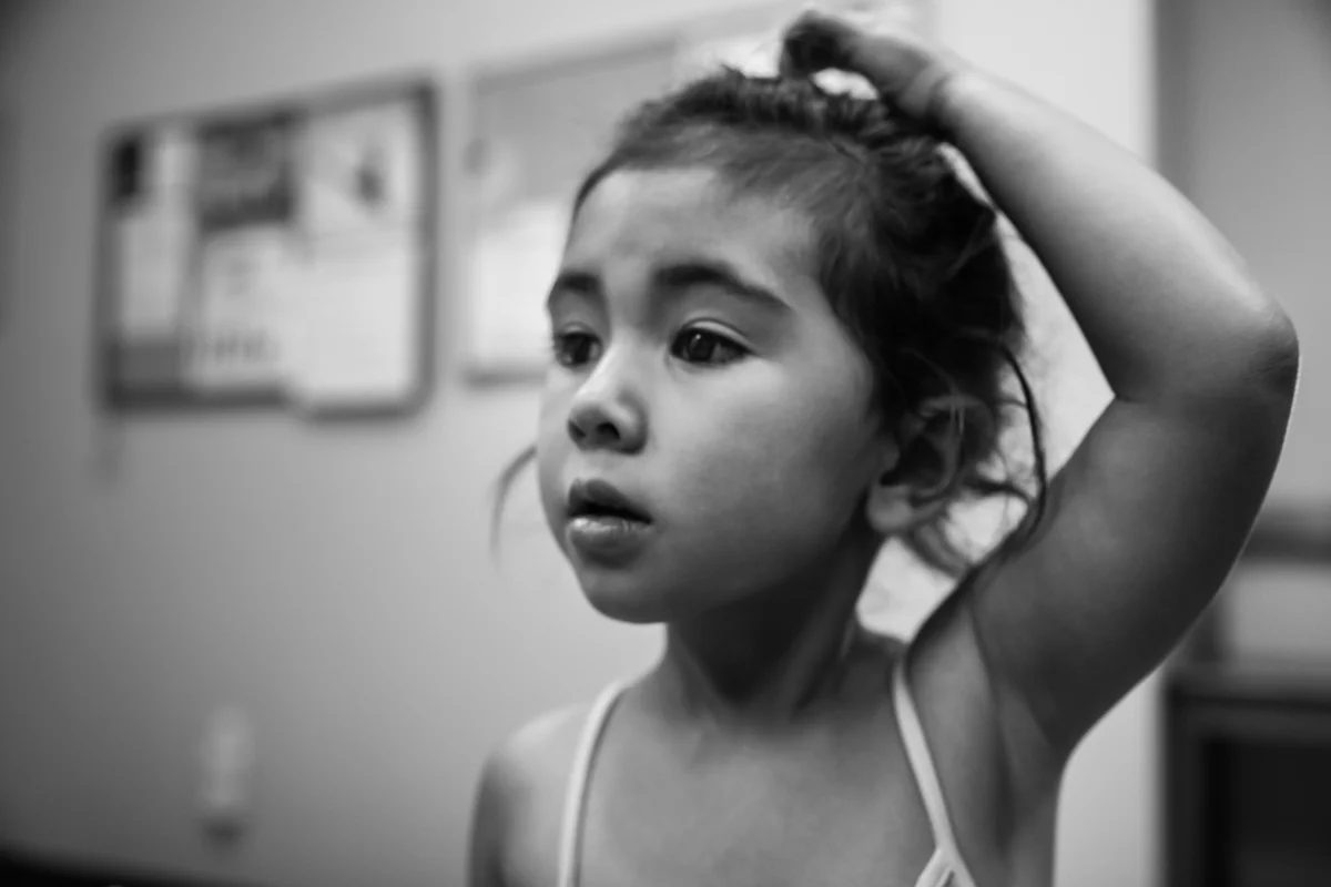 Girl looks nervously while scratching her head