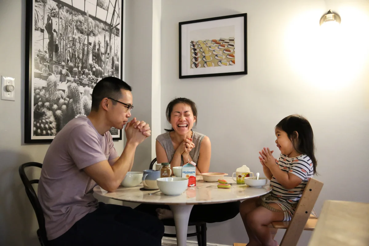 Family prays around breakfast table
