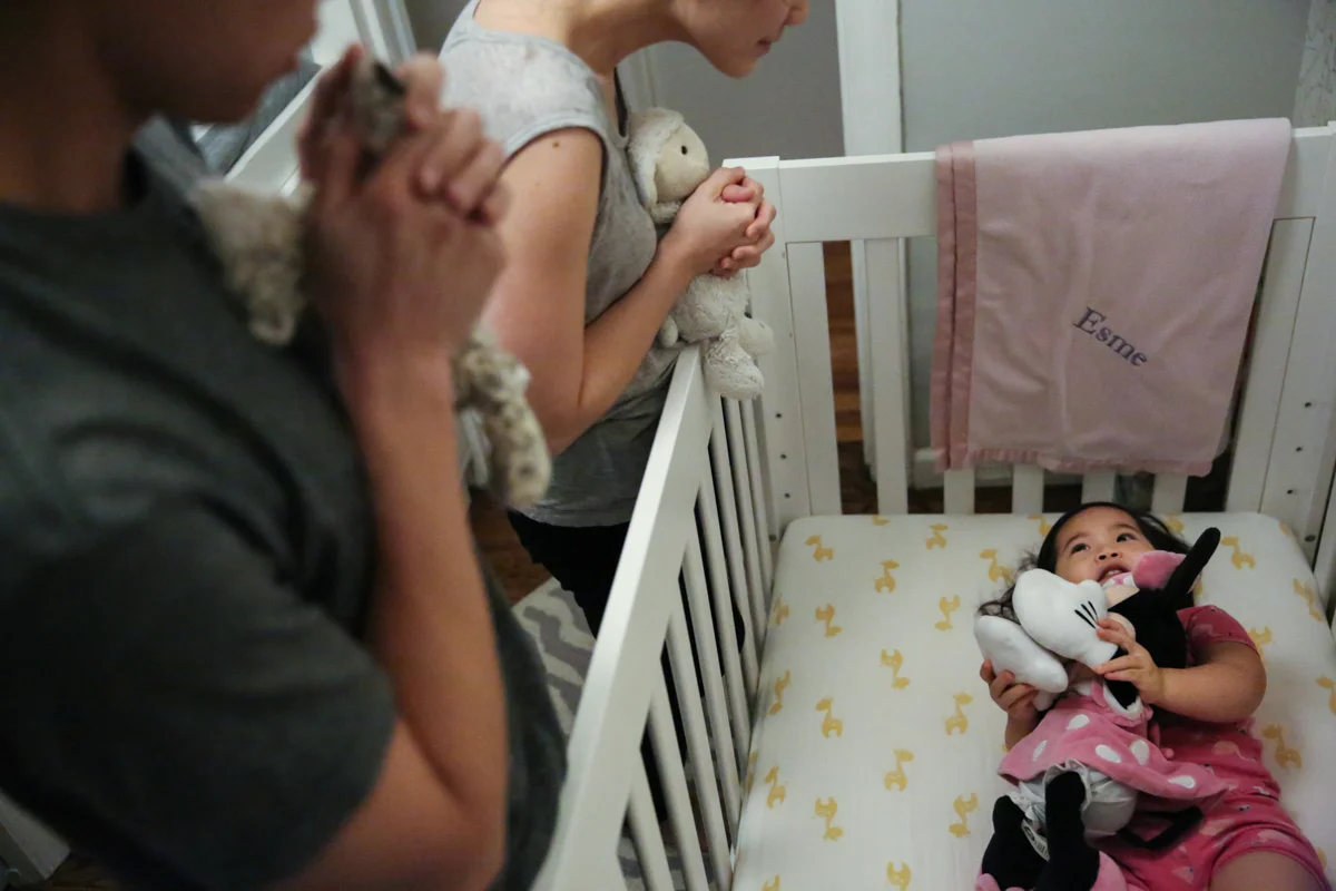 Man, woman, child, and Mini Mouse say bedtime prayers