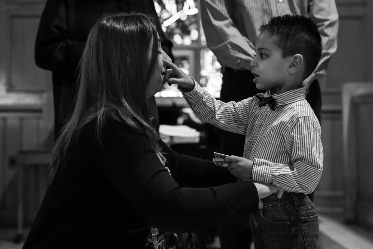 Boy touches mothers cheek with finger