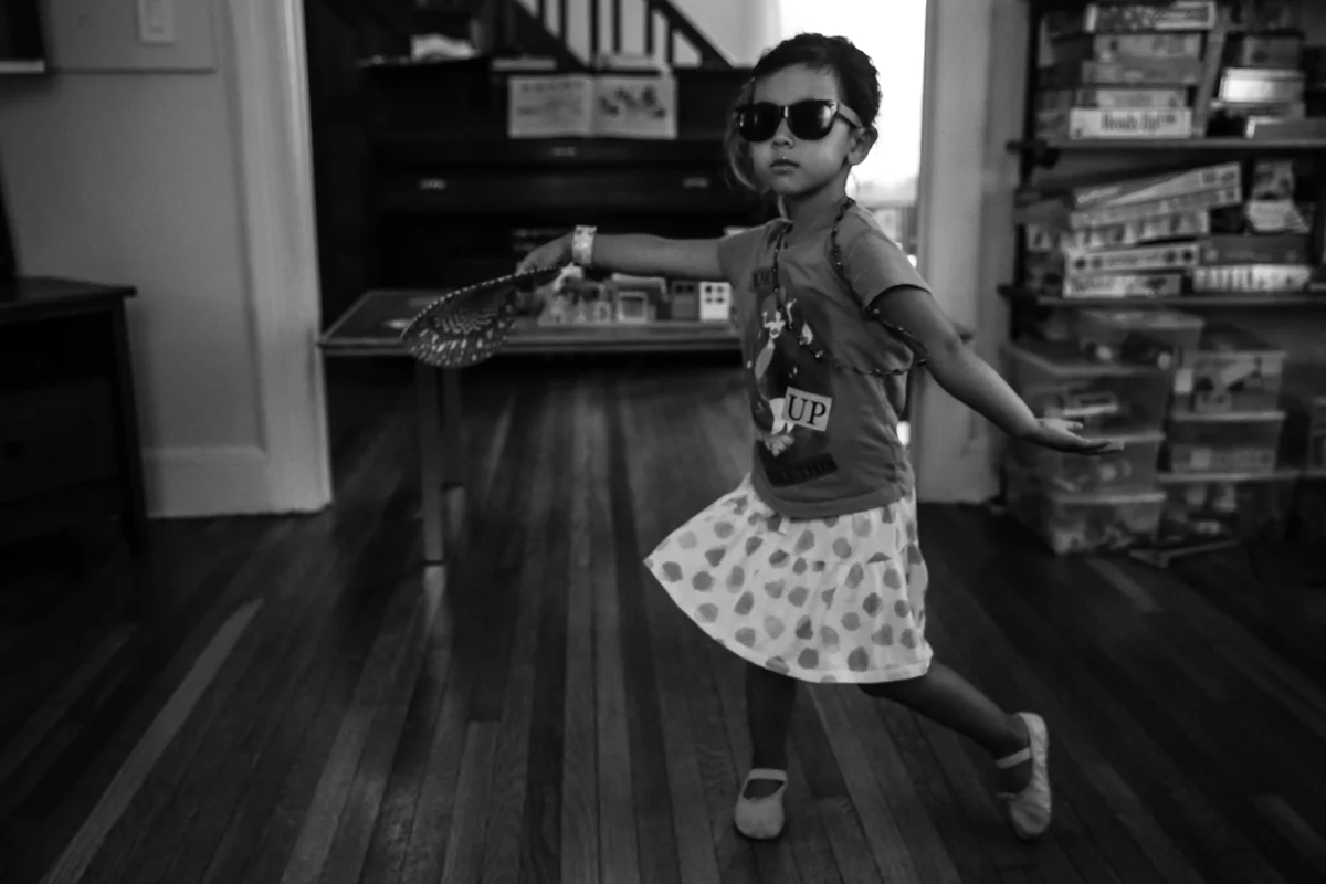 Girl with sunglasses dances in livingroom