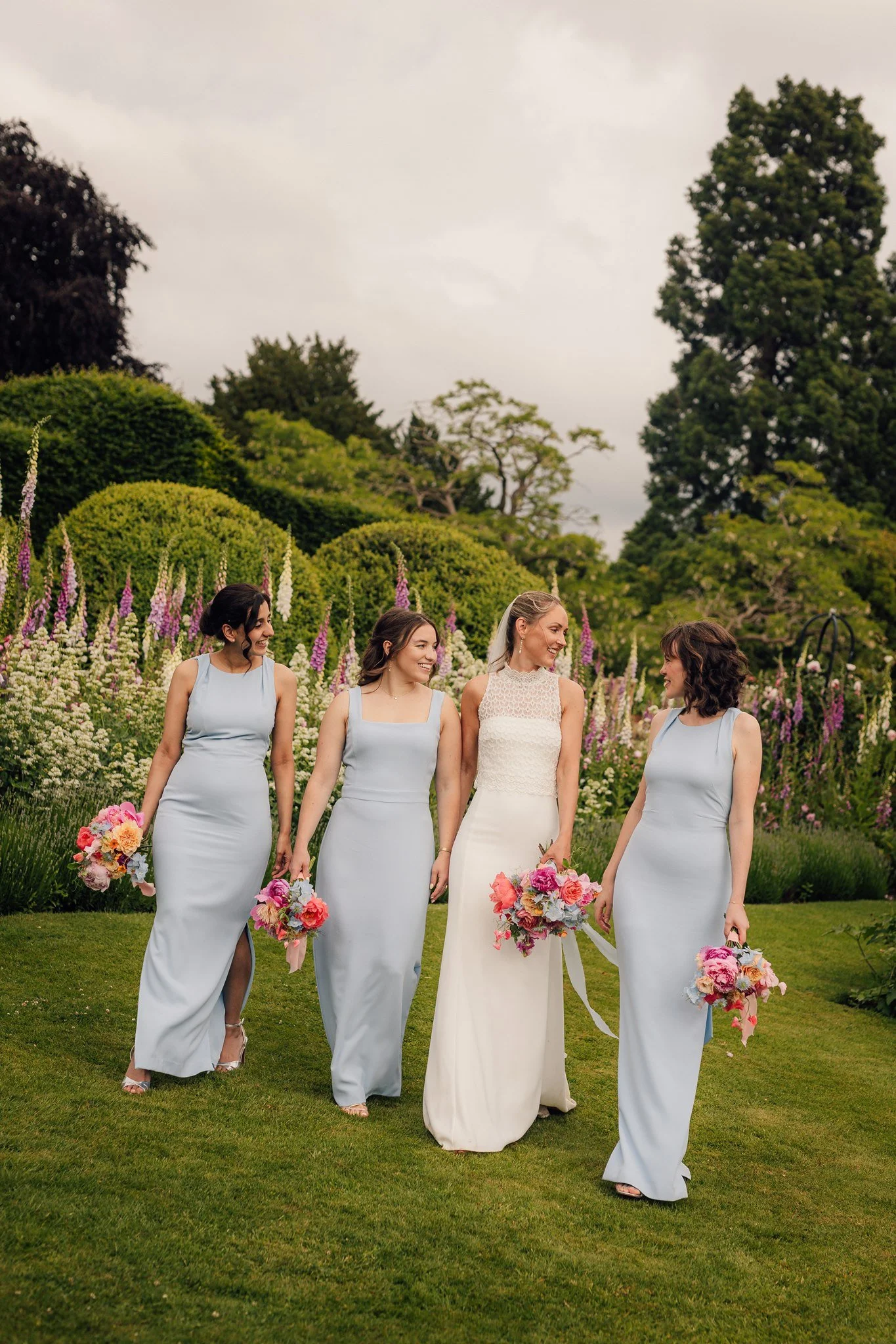 Bridesmaids walking at a wedding photographed by Andy Matheson
