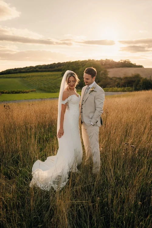 Alex and James together in a field at sunset