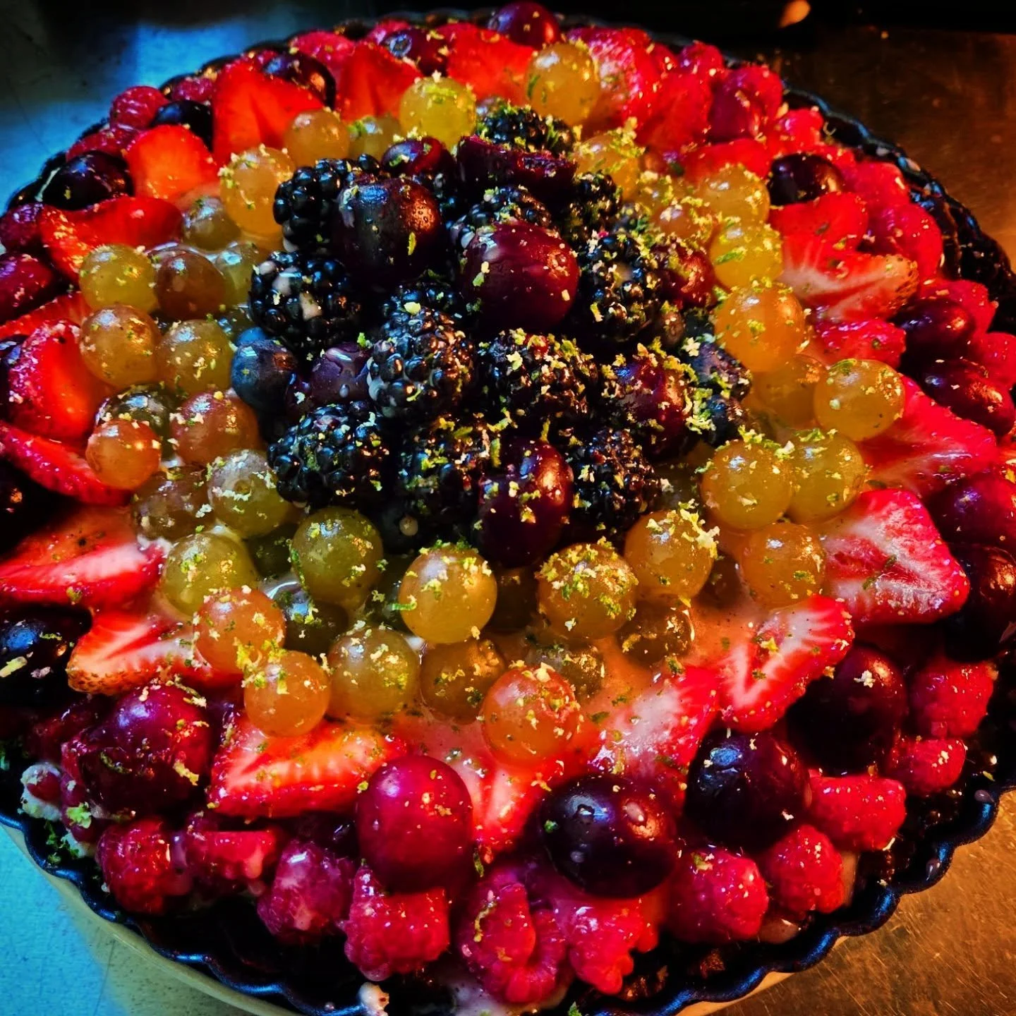 Fruit tart with custard and fresh berries. Available for holiday catering.