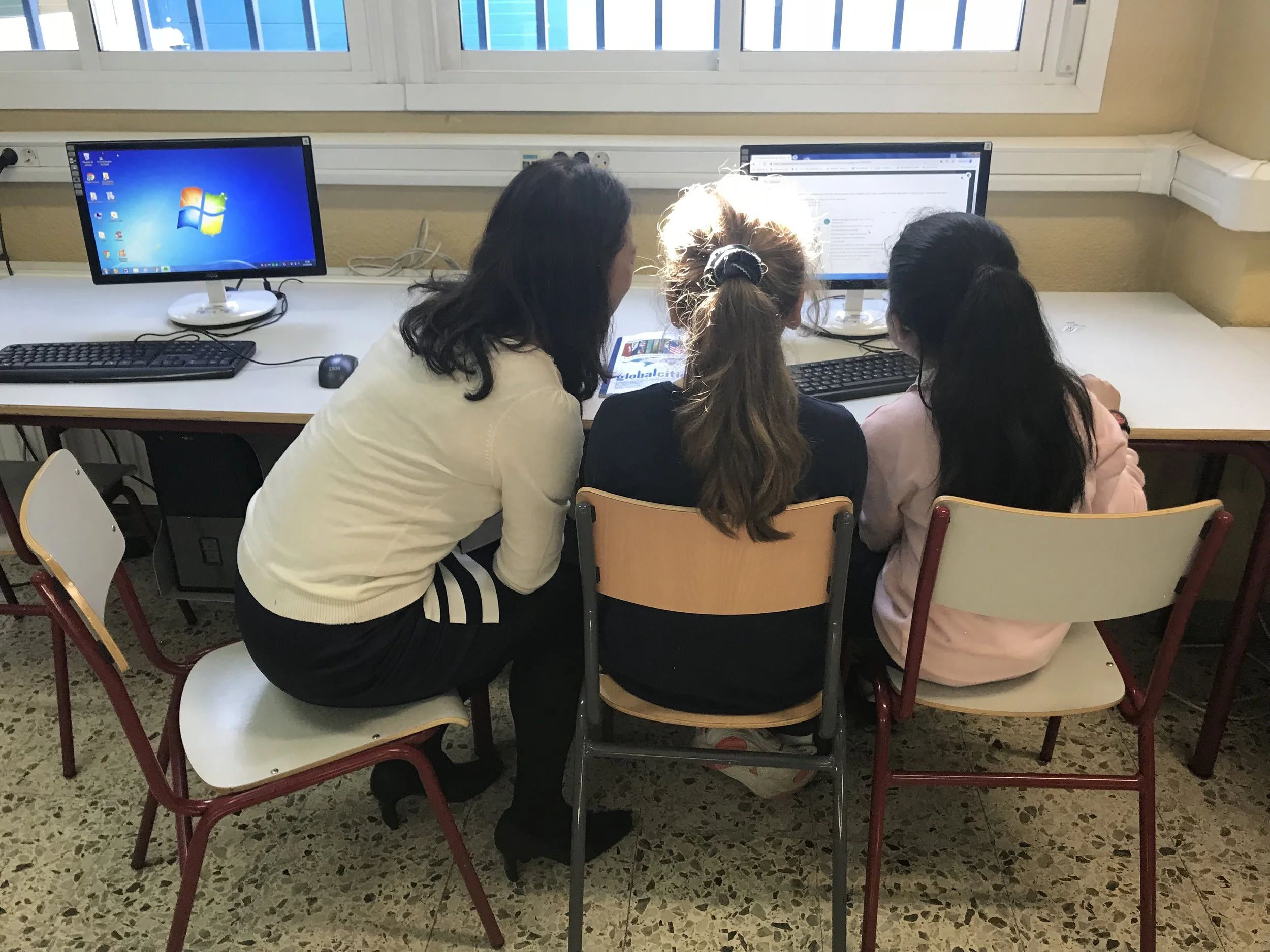 Global Scholars Madrid students show off their digital work to Nova Hung, a Global Scholars Taipei teacher joining a delegation to observe Madrid classes and teaching practices.