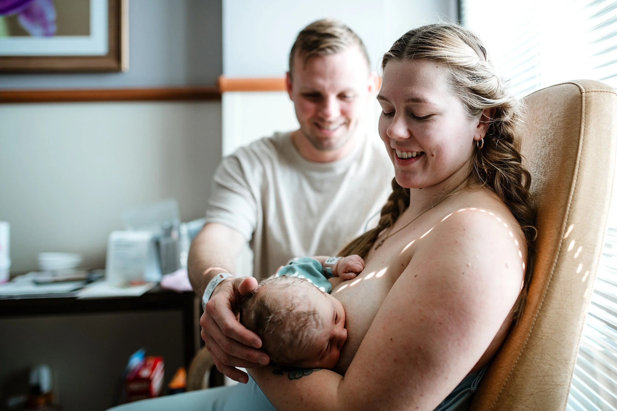 postpartum-mom-holding-newborn-fresh-48-session-pensacola.jpg