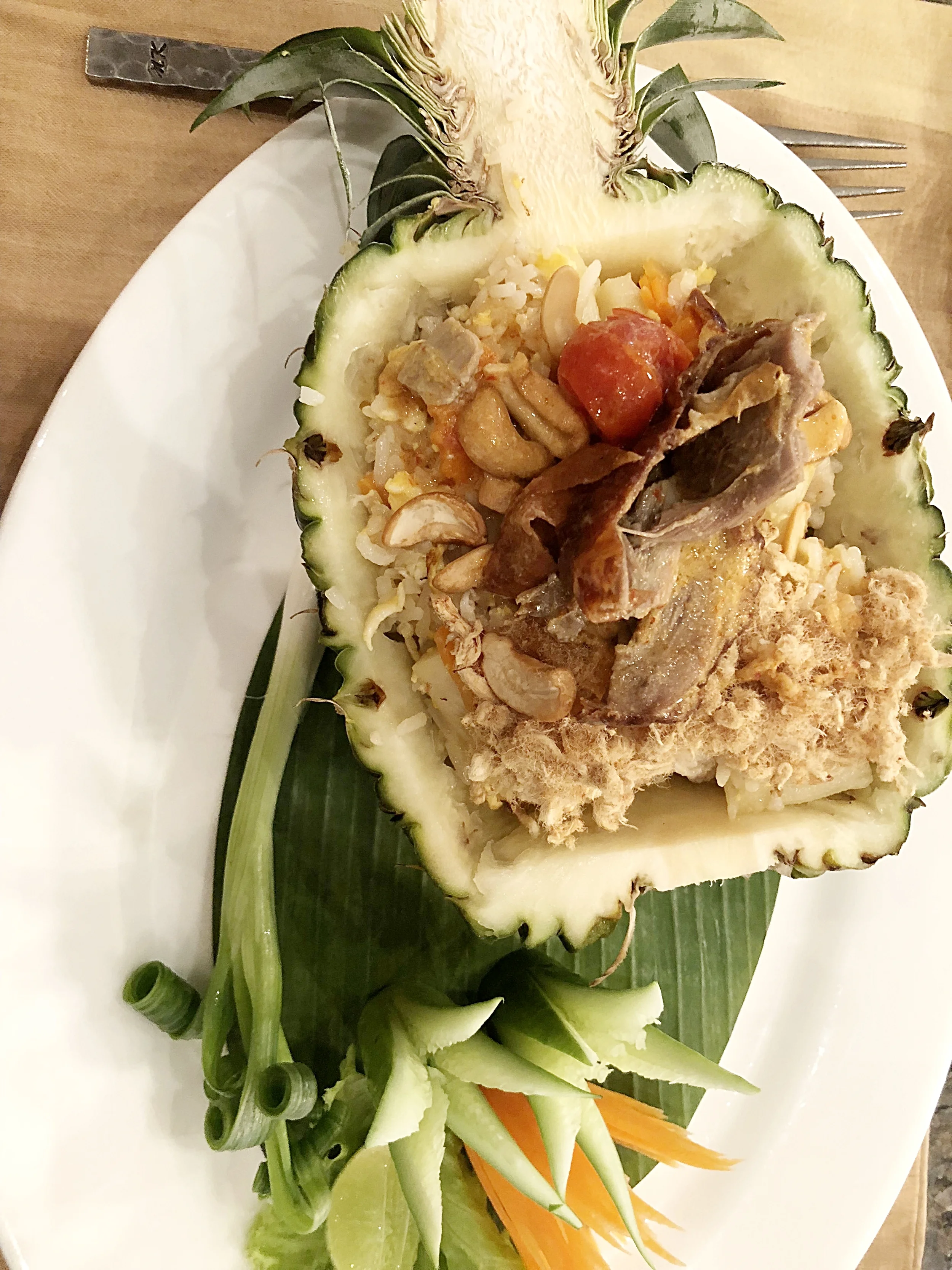 Pineapple fried rice topped with duck curry.