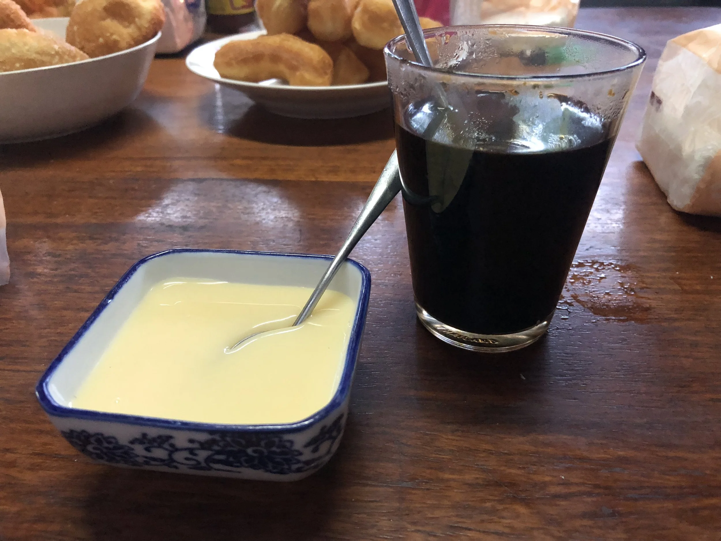 Condensed milk, coffee, and donut holes