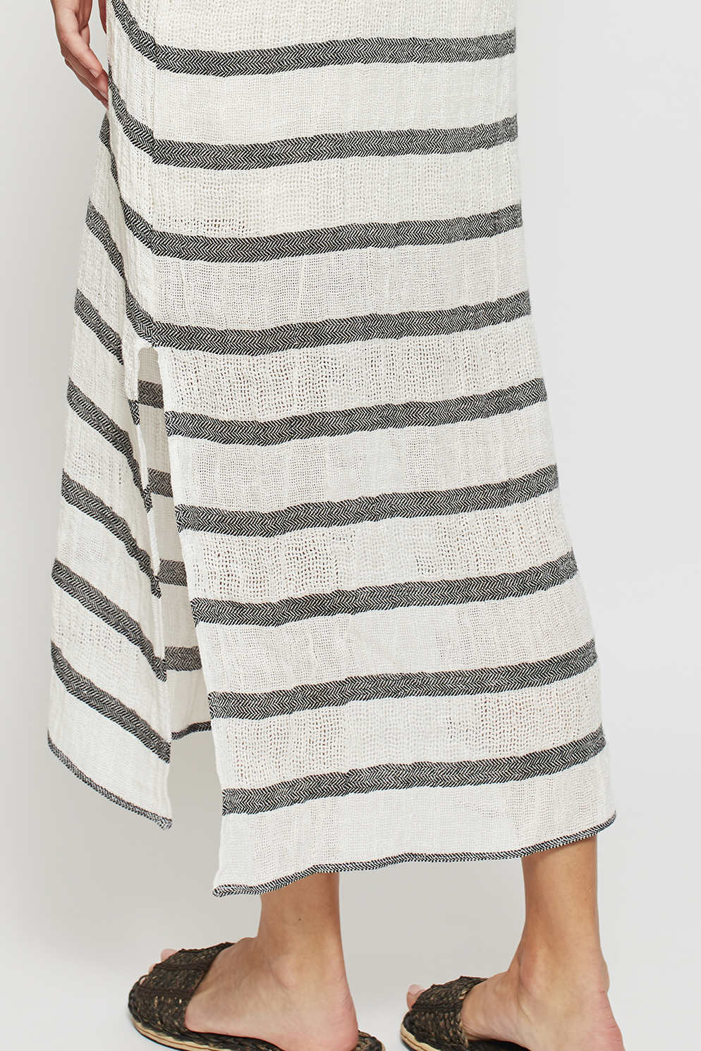 This garment also features a horizontal stripe with an intricate chevron weave, giving the kaftan it’s beautiful, textural finish. Each garment may vary slightly in relation to stripe placement, as each item is cut individually, making them all moderately unique.