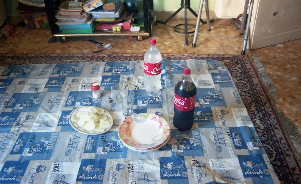 Pre-Supper (2016) Pakistani refugees preparing a summer afternoon meal. Meals are traditionally shared while sitting on the floor. Battistini, Rome, Italy Kodak Portra 35mm color film scan