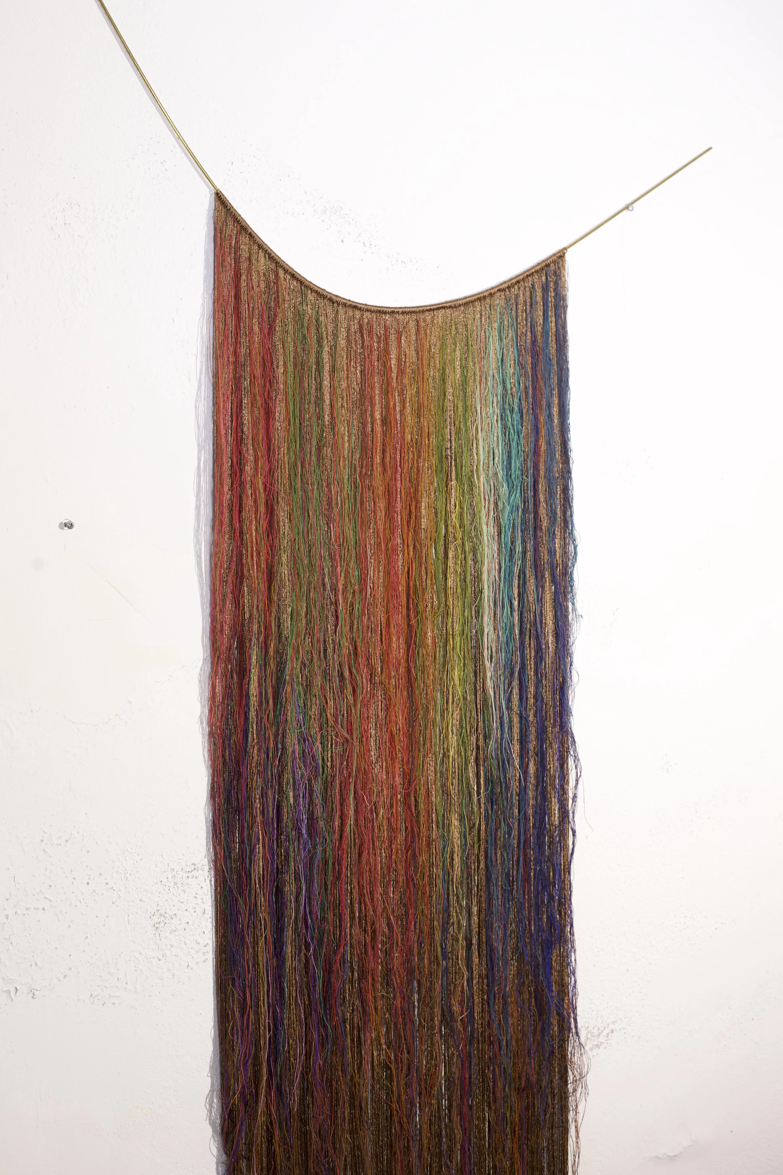 The colour of the mountains and everything else, 2023, nylon thread, wool thread, brass