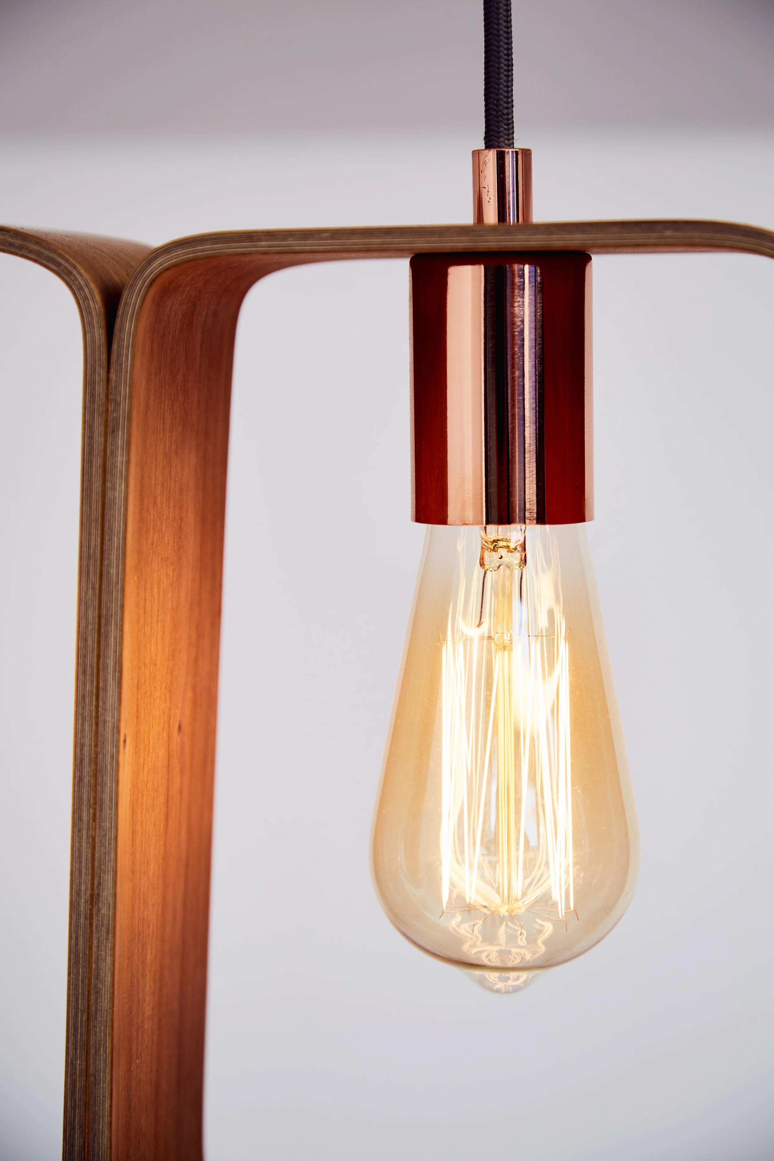 Close up of Fab chandelier in copper fittings and cherry veneer by Lozi