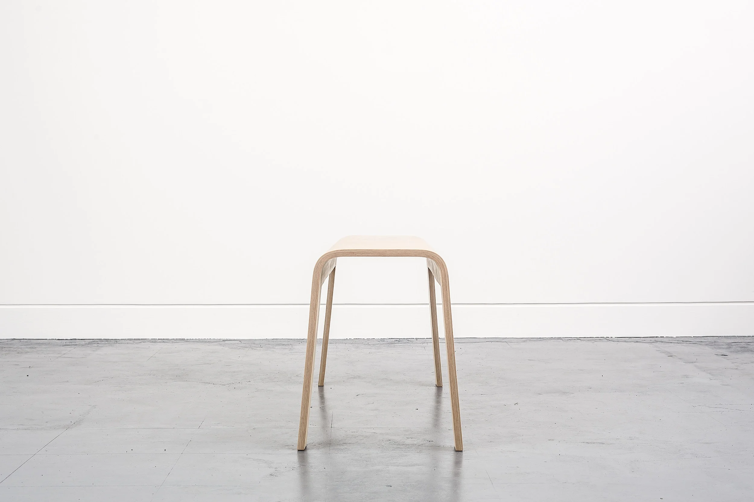 Curved plywood stool by Lozi