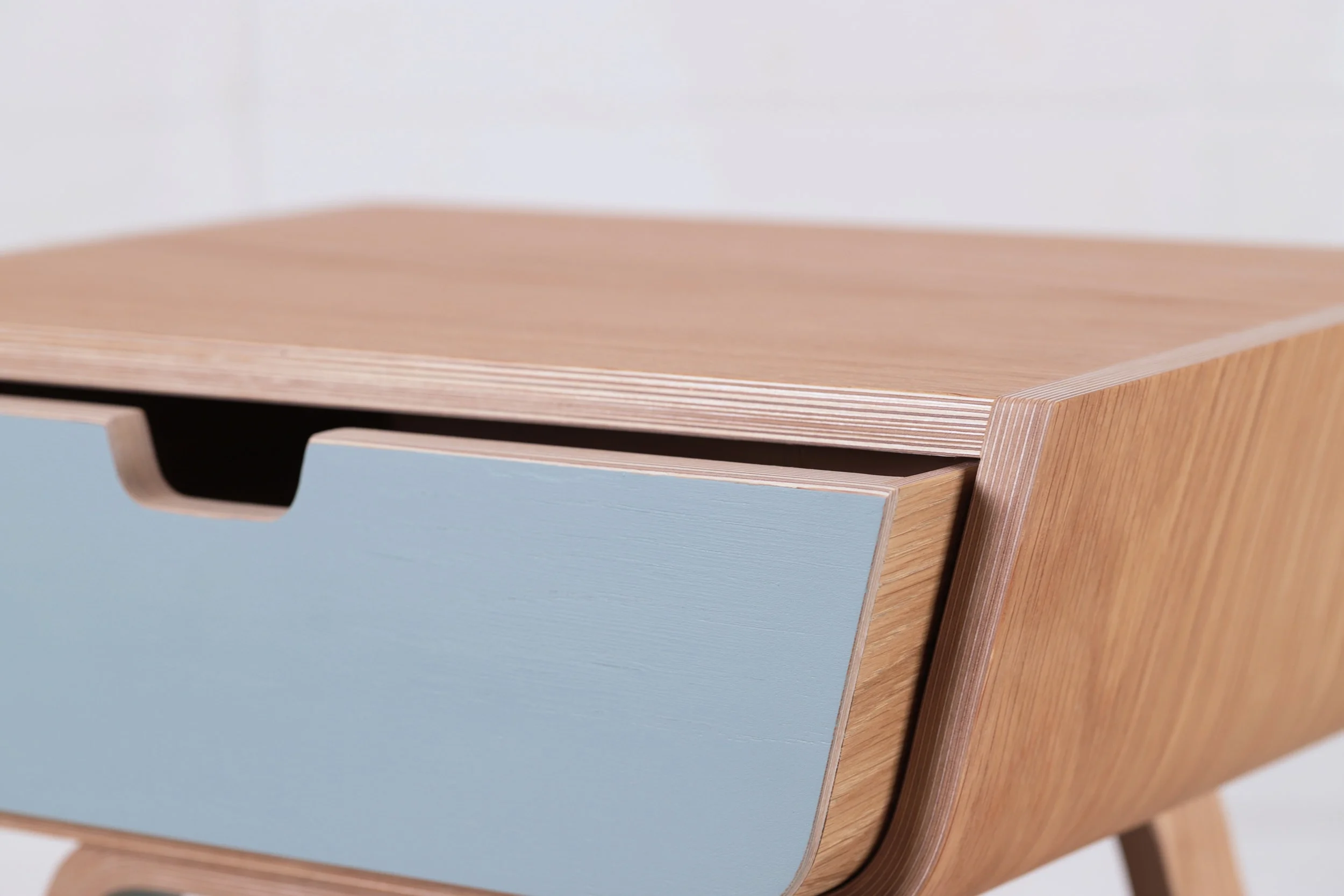 A close up of the drawer in Lozi's curved plywood bedside tables