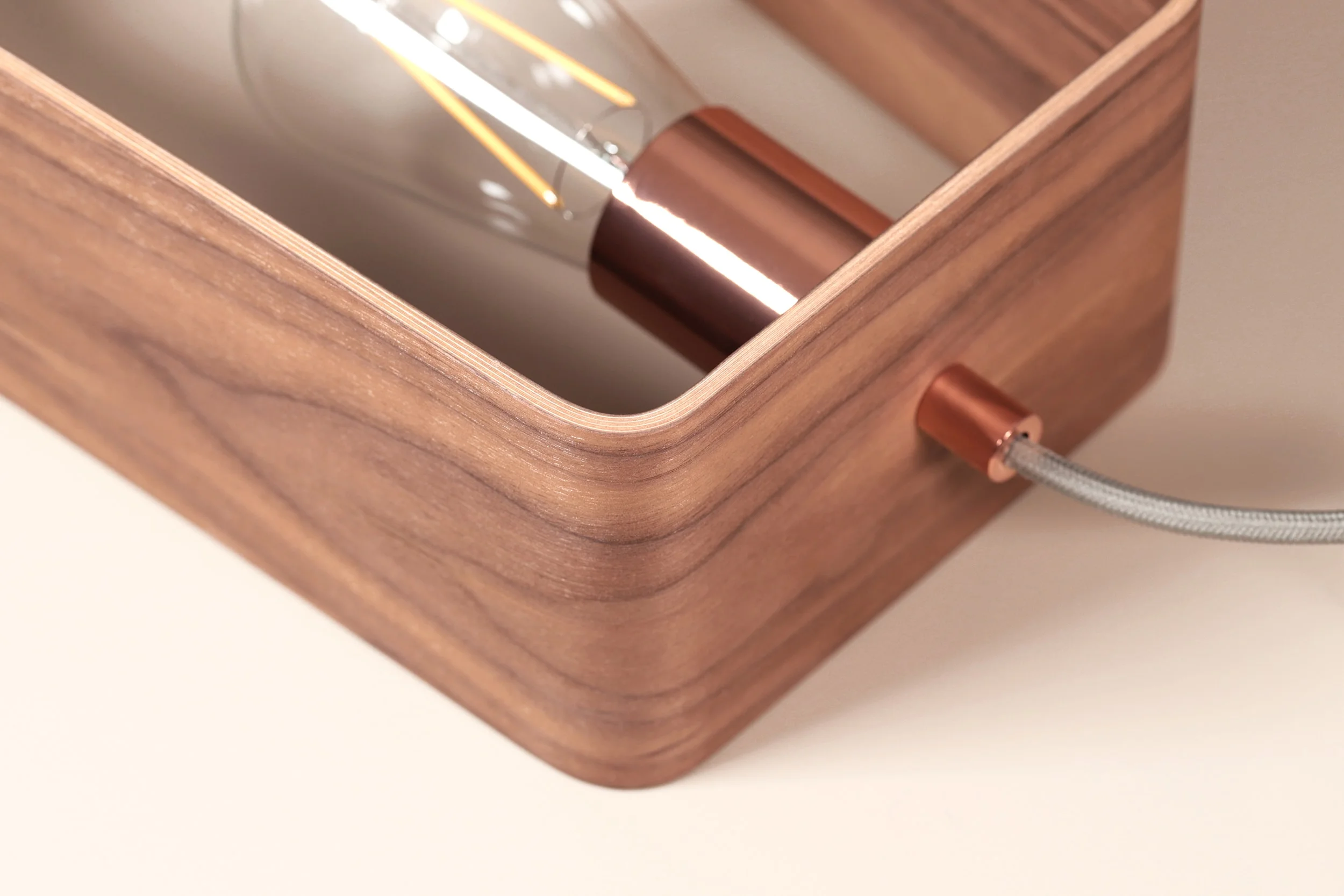 Close up of the bulb fitting in Lozi's curved plywood Fab Lamp