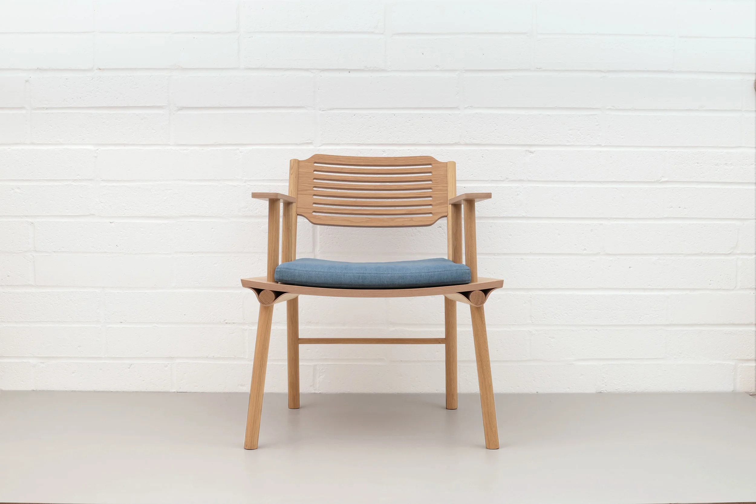 Front view of Lozi's lounge armchair, the Rio Chair, made from curved plywood