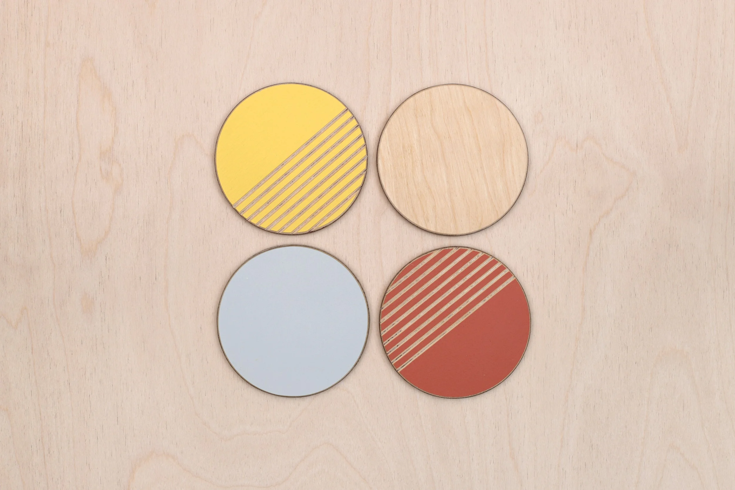 The Summer colour-way for the plywood coasters Lozi's £9.99 Collection made from waste materials