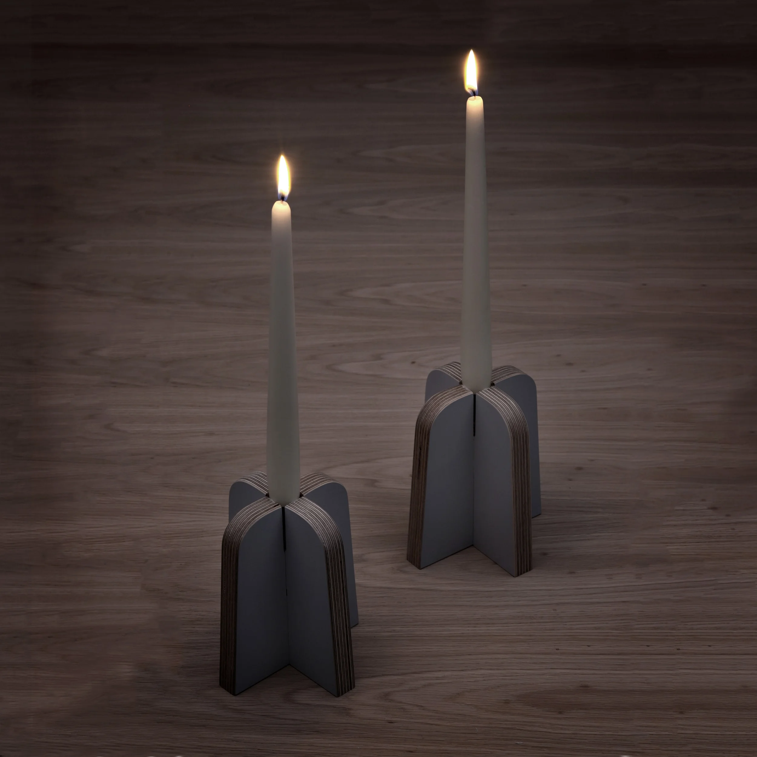 A pair of the plywood candle holders from Lozi's £9.99 Collection made from waste materials