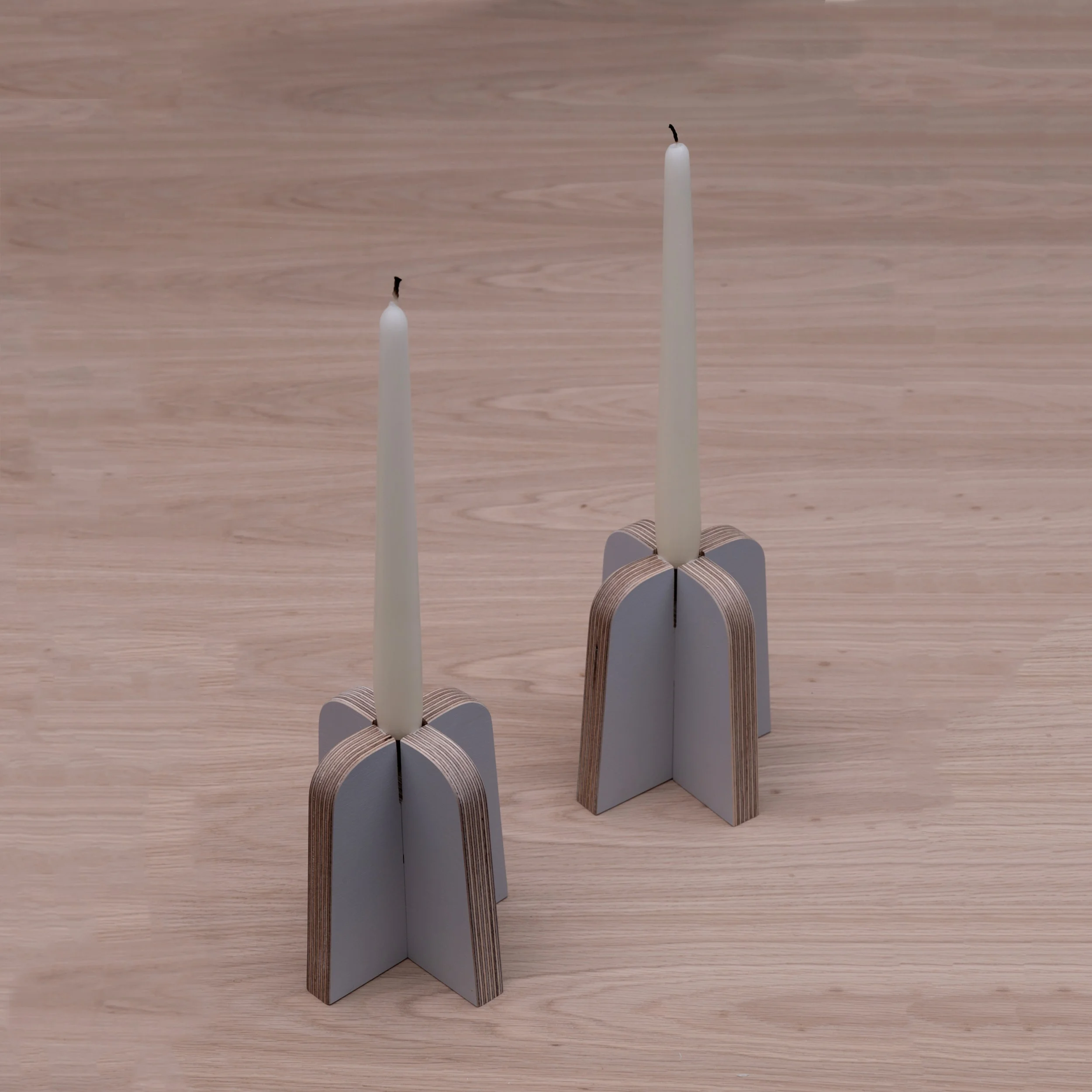 A pair of the plywood candle holders from Lozi's £9.99 Collection made from waste materials