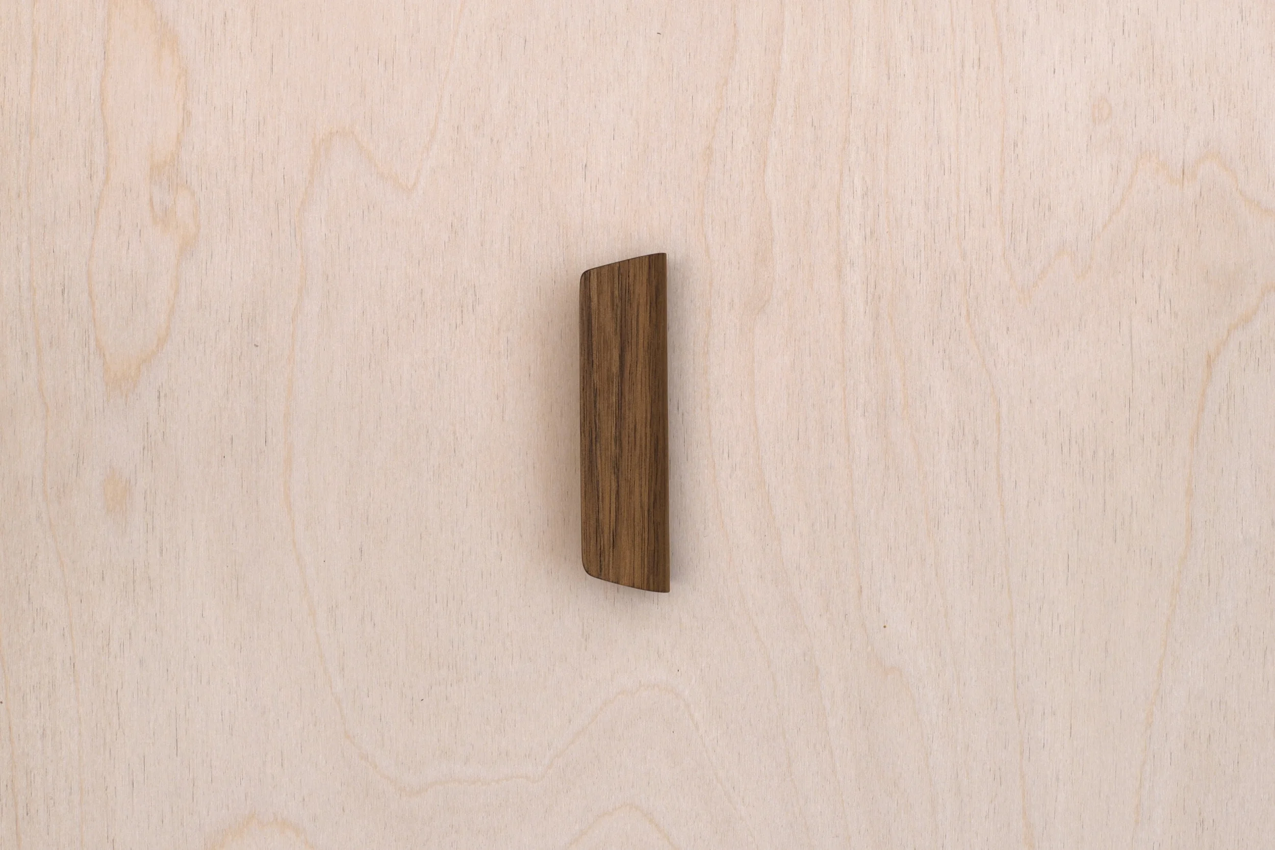 A pair of curved plywood easy bag handles from Lozi's £9.99 collection made from waste materials