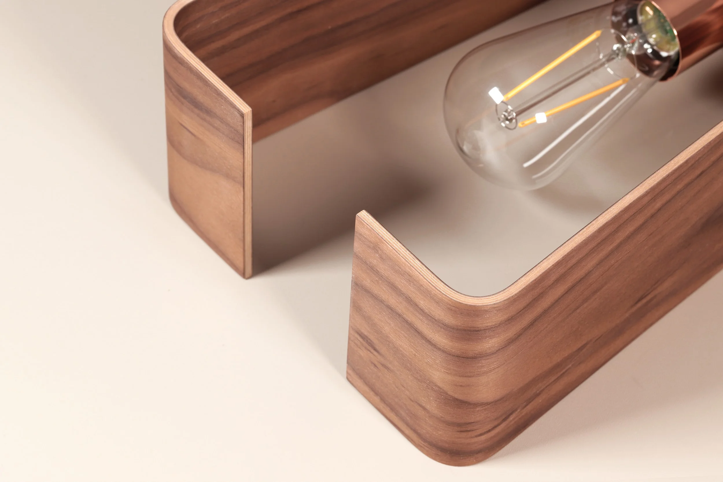 Close up of a single fab lamp pendant from Lozi's curved plywood furniture collection
