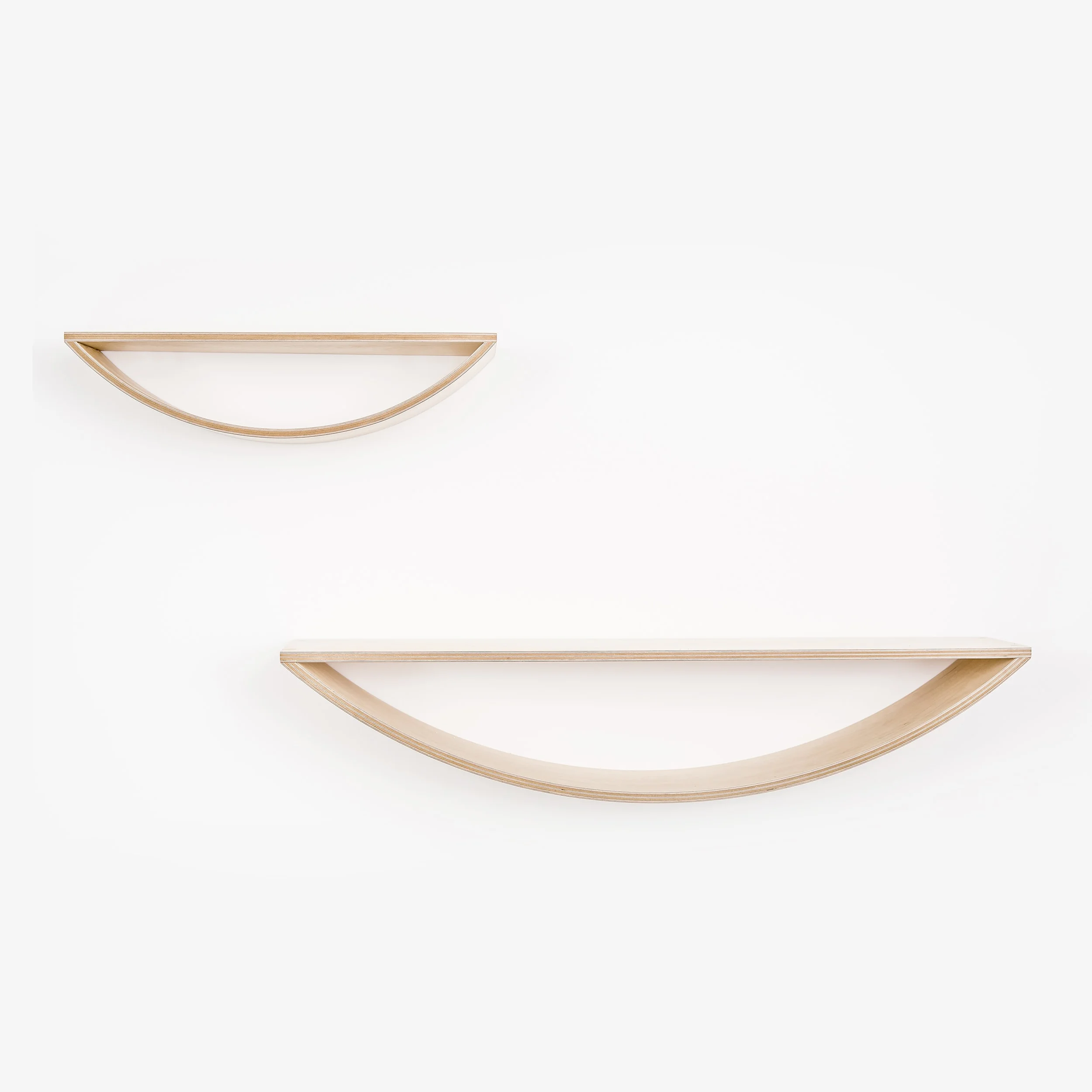 A small and a large curved plywood smile shelf by Lozi