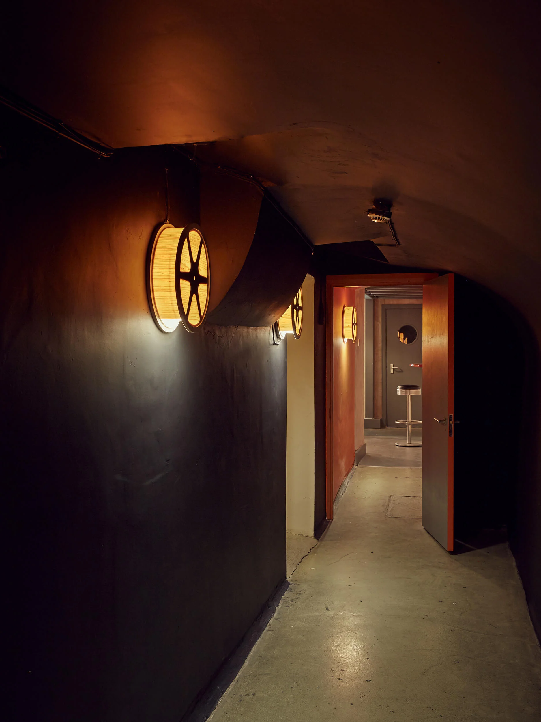 The corridor leading to the bar, illuminated with film reel sunset lamps.