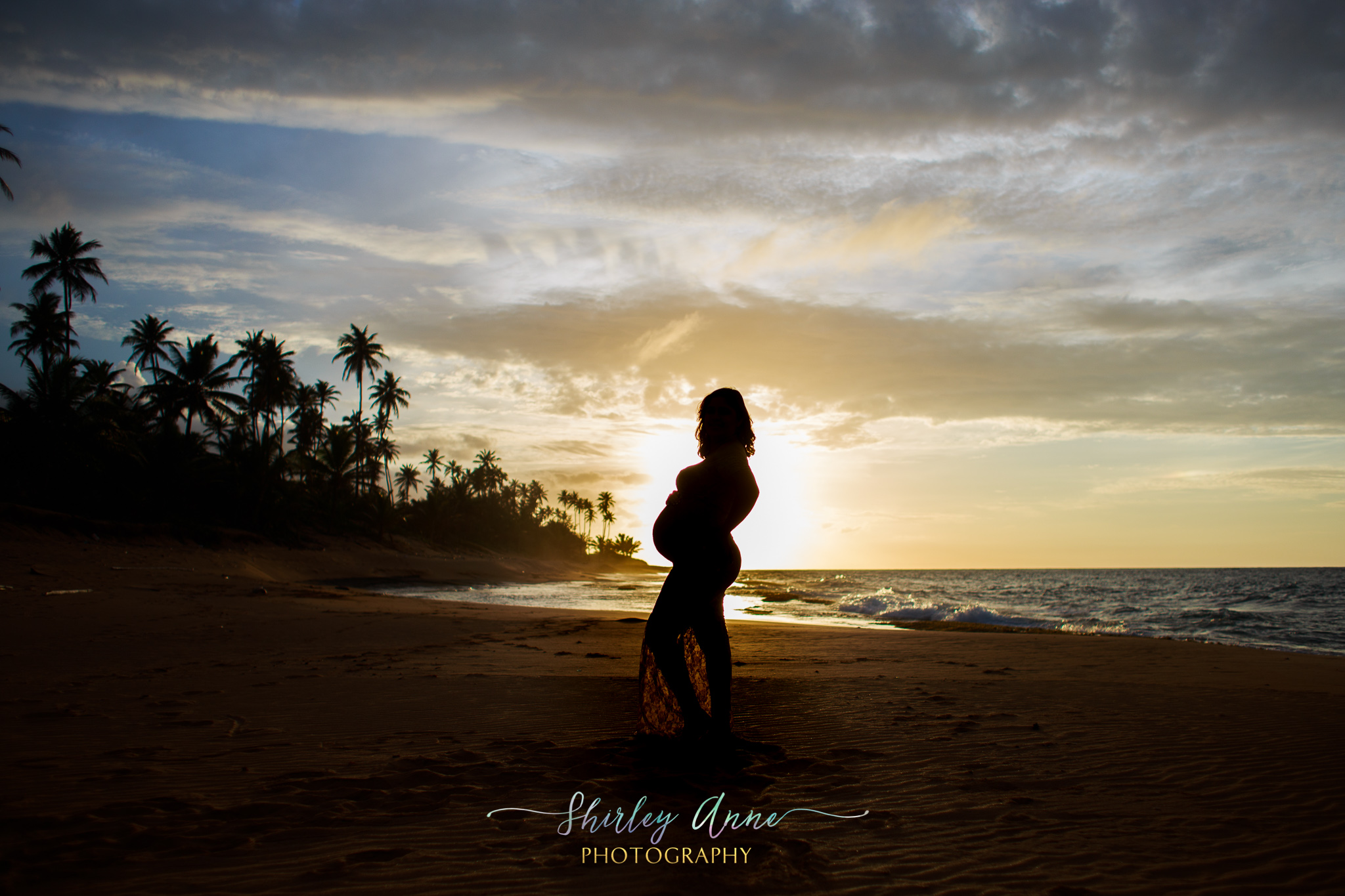 sunset with silhoutte of pregnant mom during maternity session