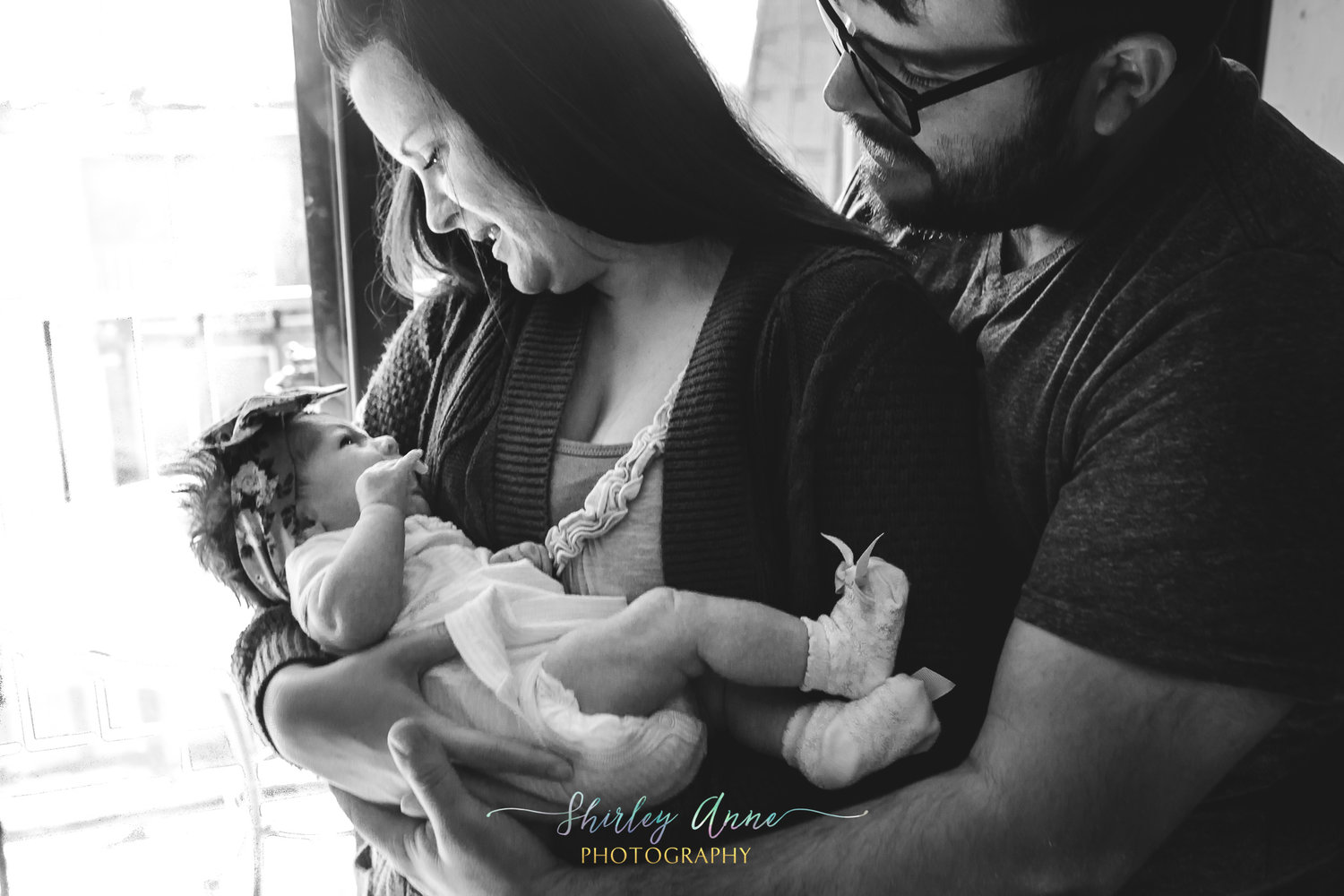 infant baby girl with mom and dad in home session