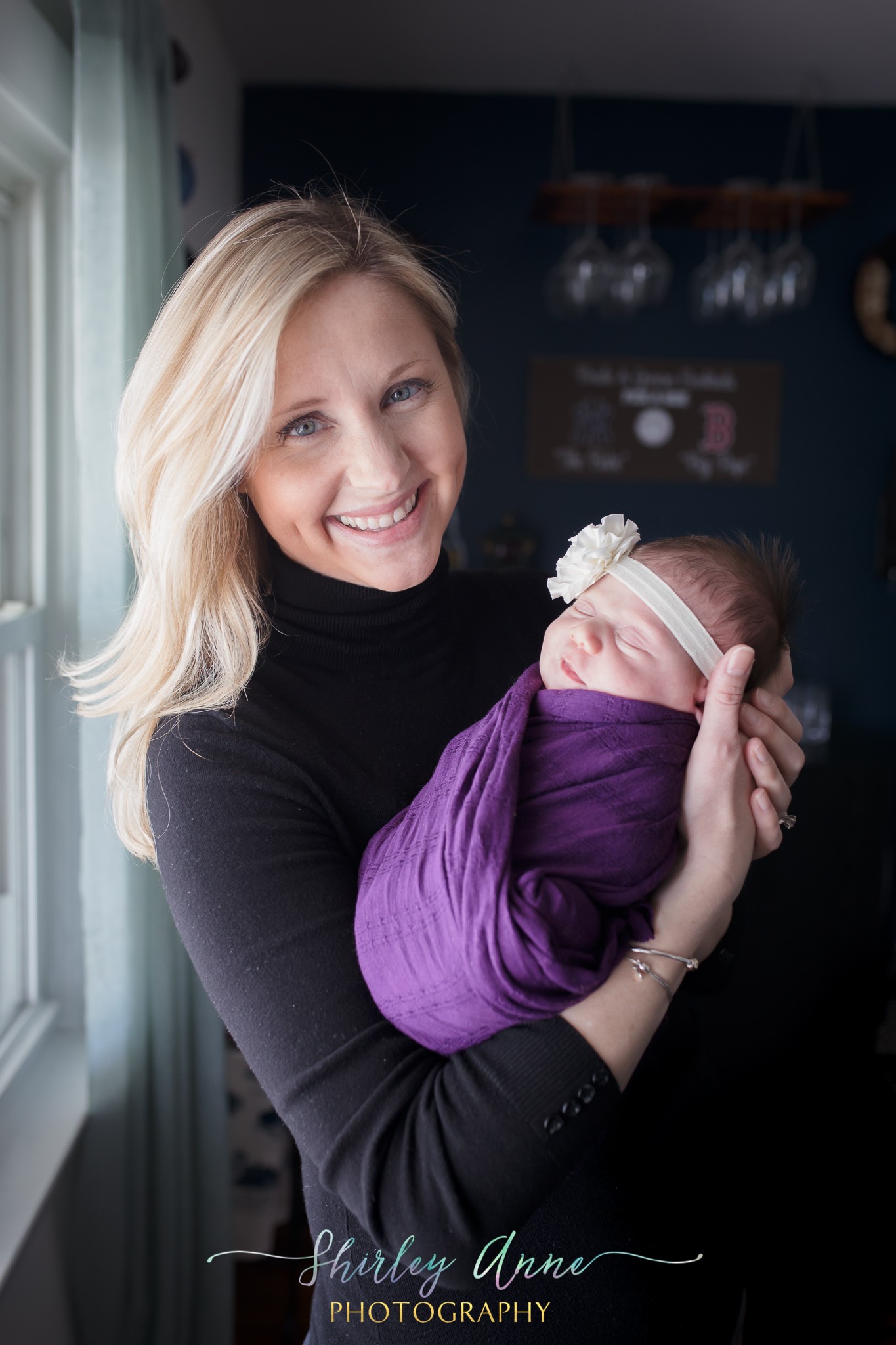 mother holding baby during newborn session