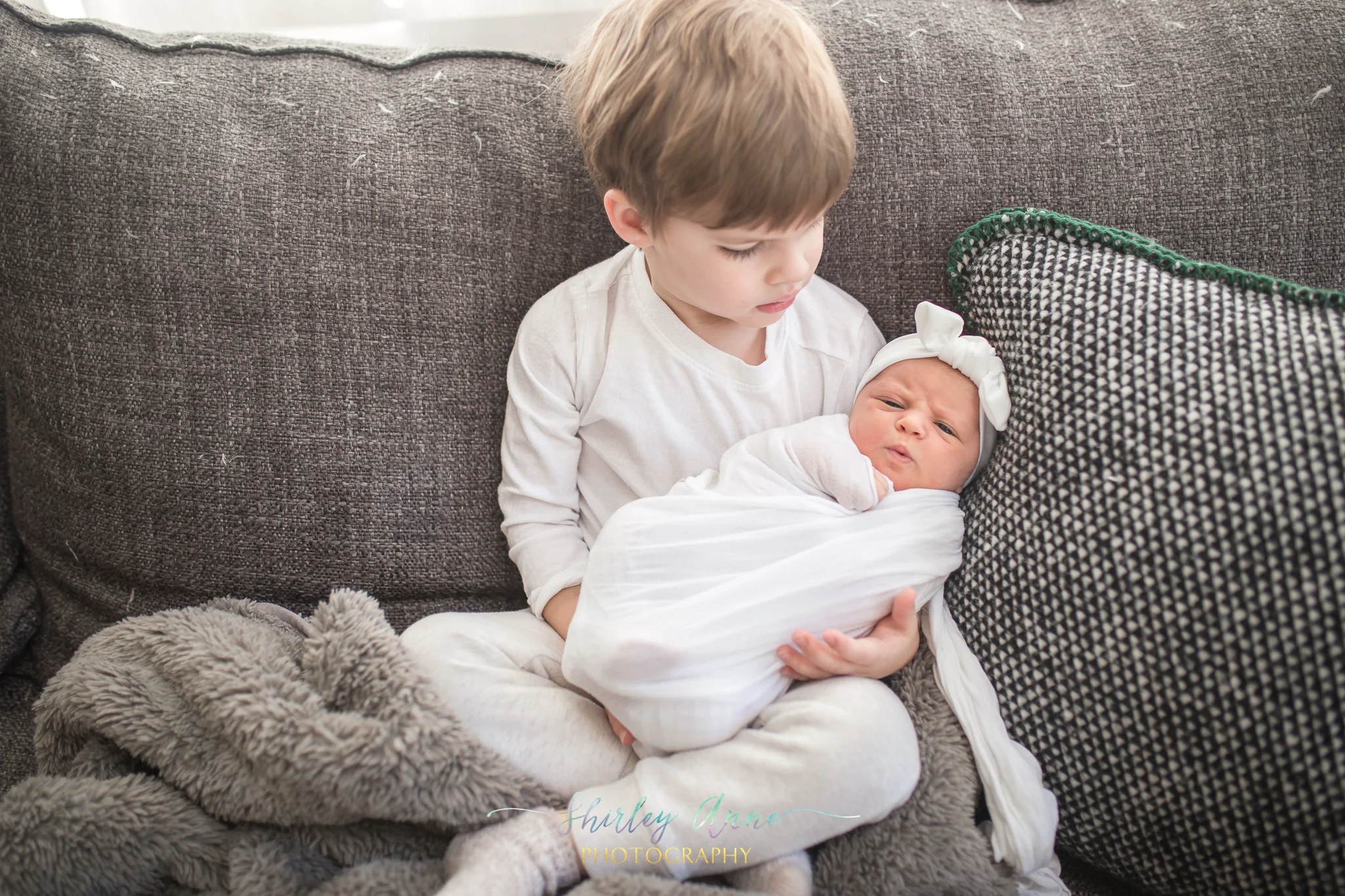 older brother with newborn baby girl