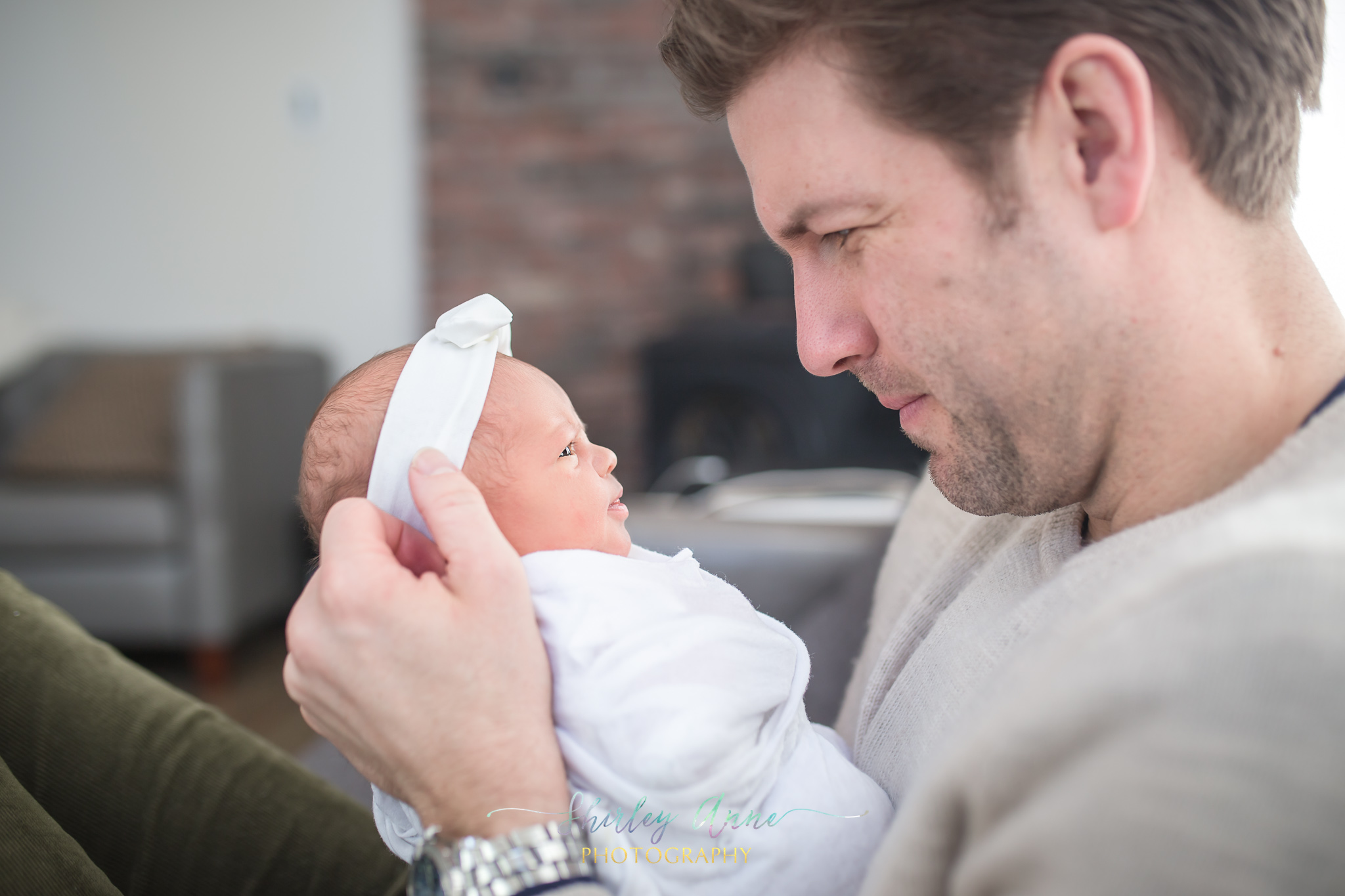 dad and newborn baby girl at home