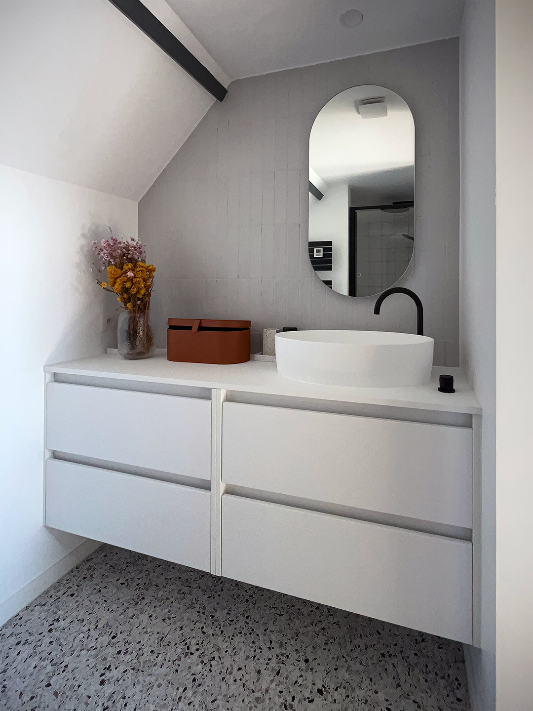 Meuble lavabeau sur-mesure avec plan de travail et finitions claires pour agrandir l'espace d'une petite salle d'eau